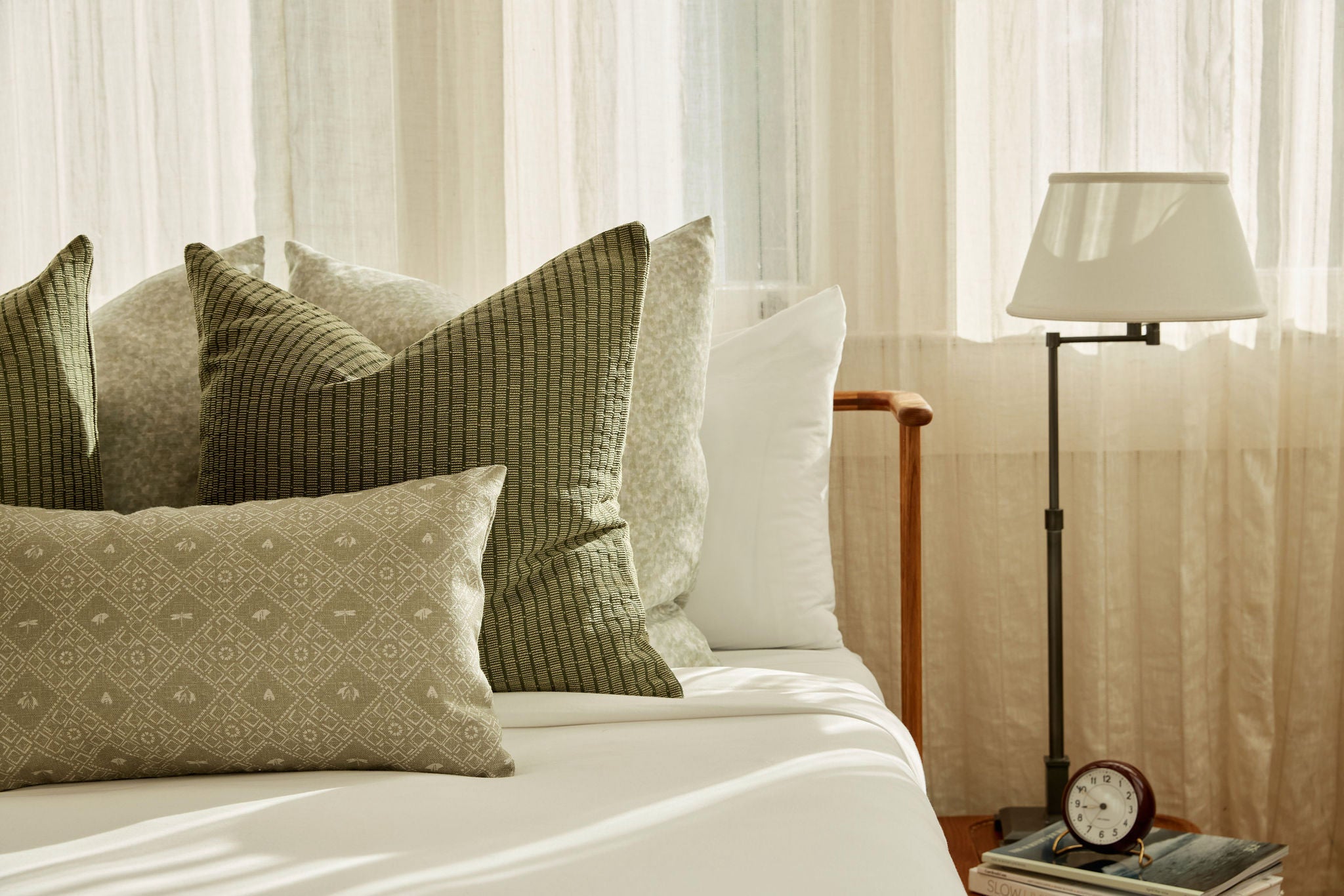 Americana pillow in Edamame styled by Emily Daws – shown on a rustic bench with handmade quilts