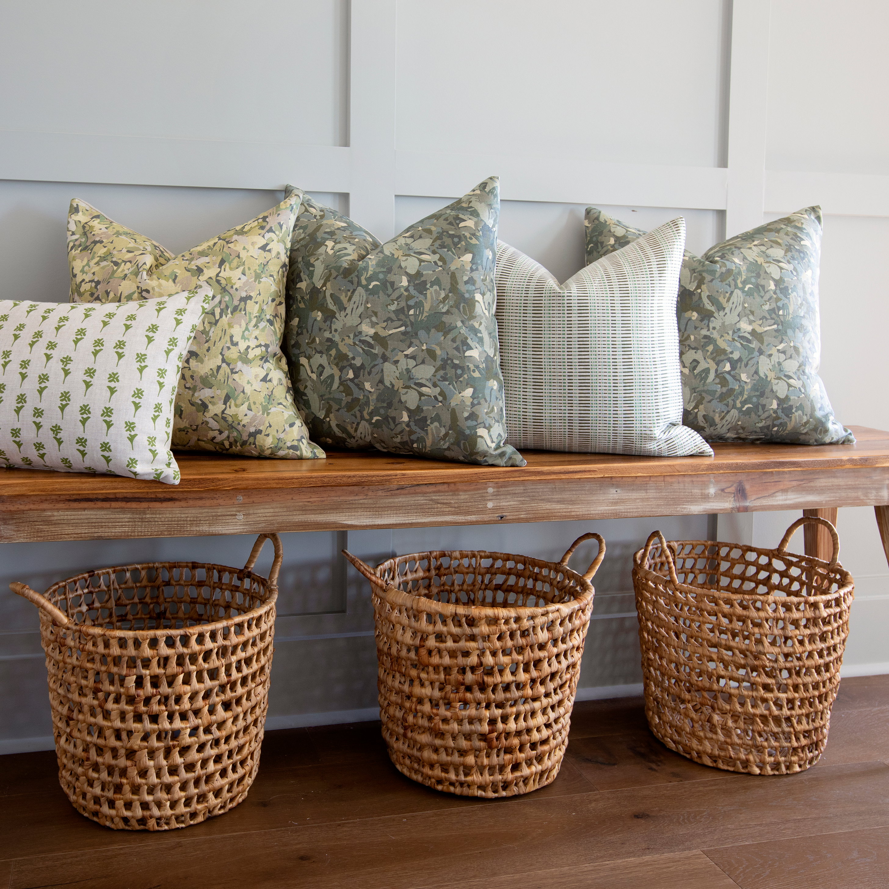 Birch pillow in Evergreen styled by Emily Daws β layered with quilts in a woodland bedroom setting
