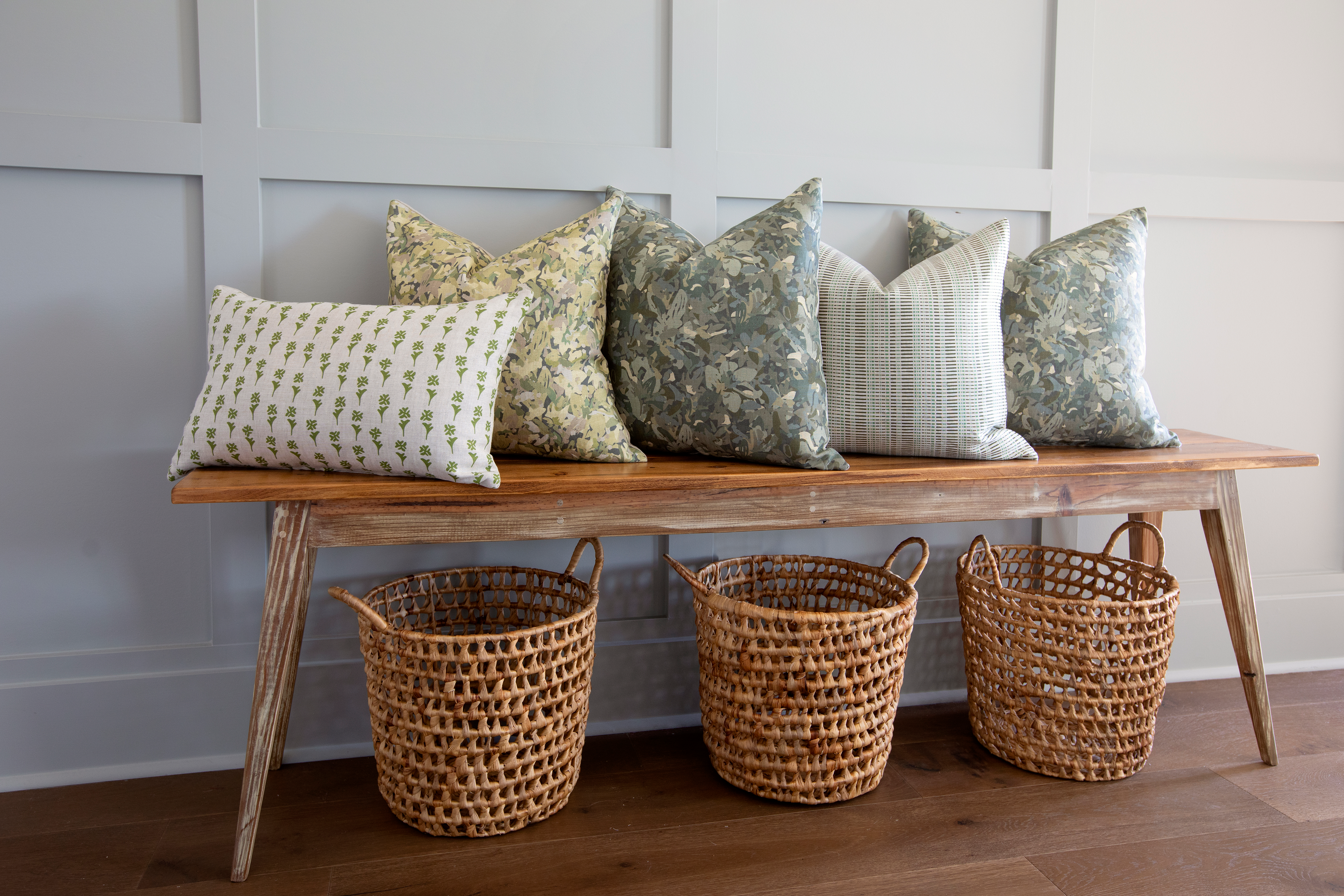 Birch pillow in Evergreen styled by Emily Daws – layered with quilts in a woodland bedroom setting