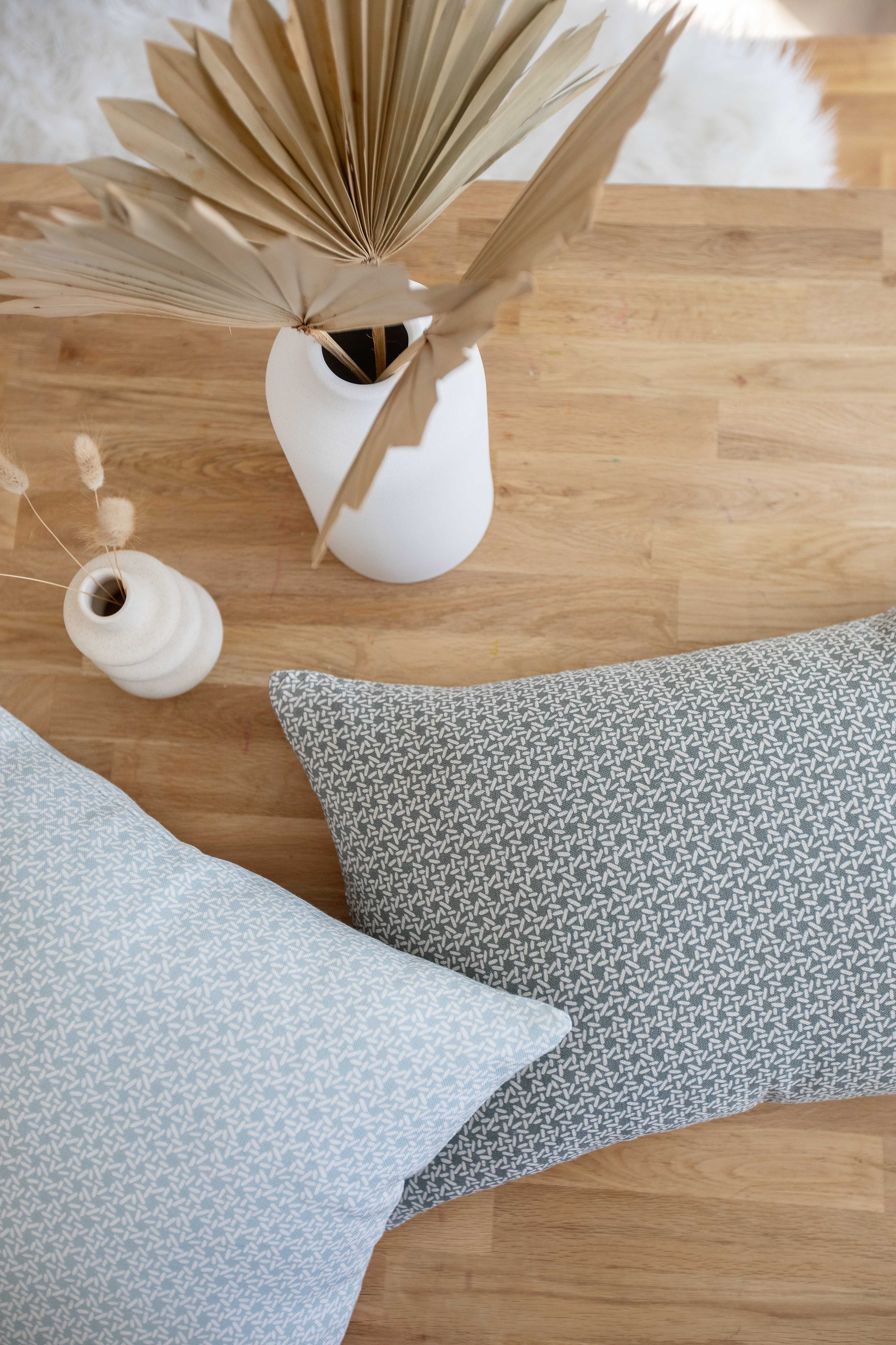 Carolina Rice pillow in Chambray styled by Emily Daws – placed on a vintage settee in a Charleston cottage