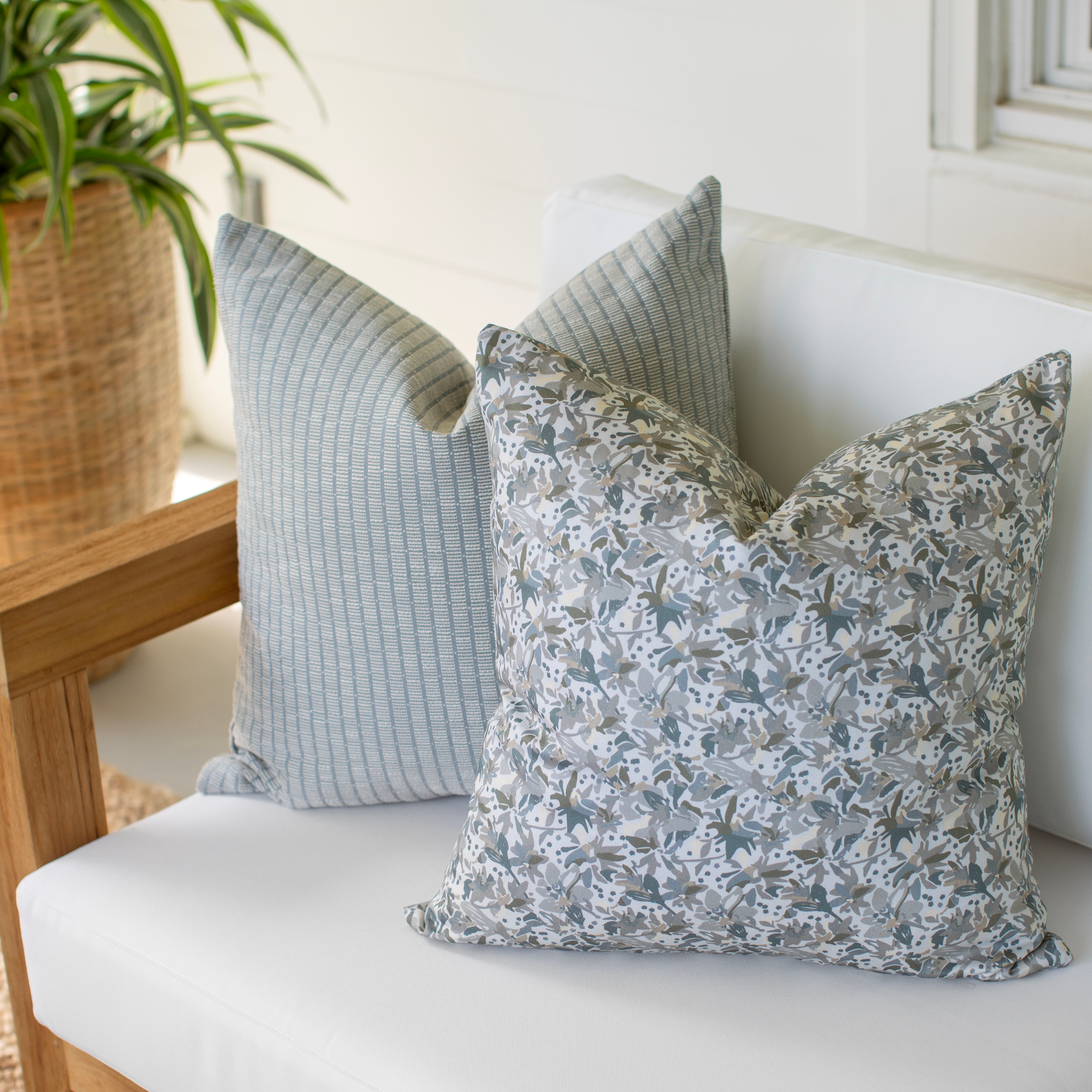 Eden pillow in Lichen styled by Emily Daws – placed on a vintage chair with warm wood tones