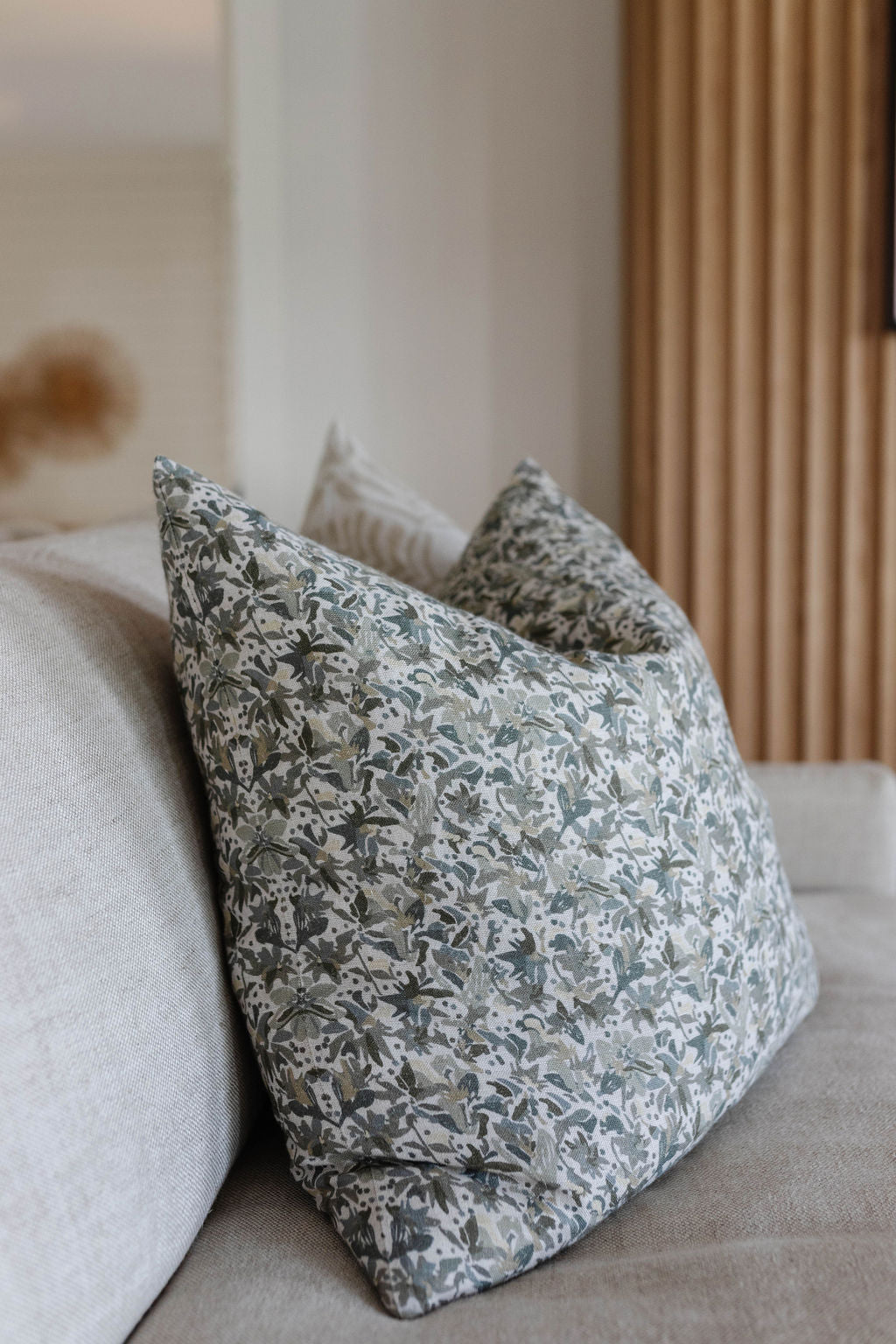 Eden pillow in Lichen styled by Emily Daws – layered with quilts in a woodland bedroom setting