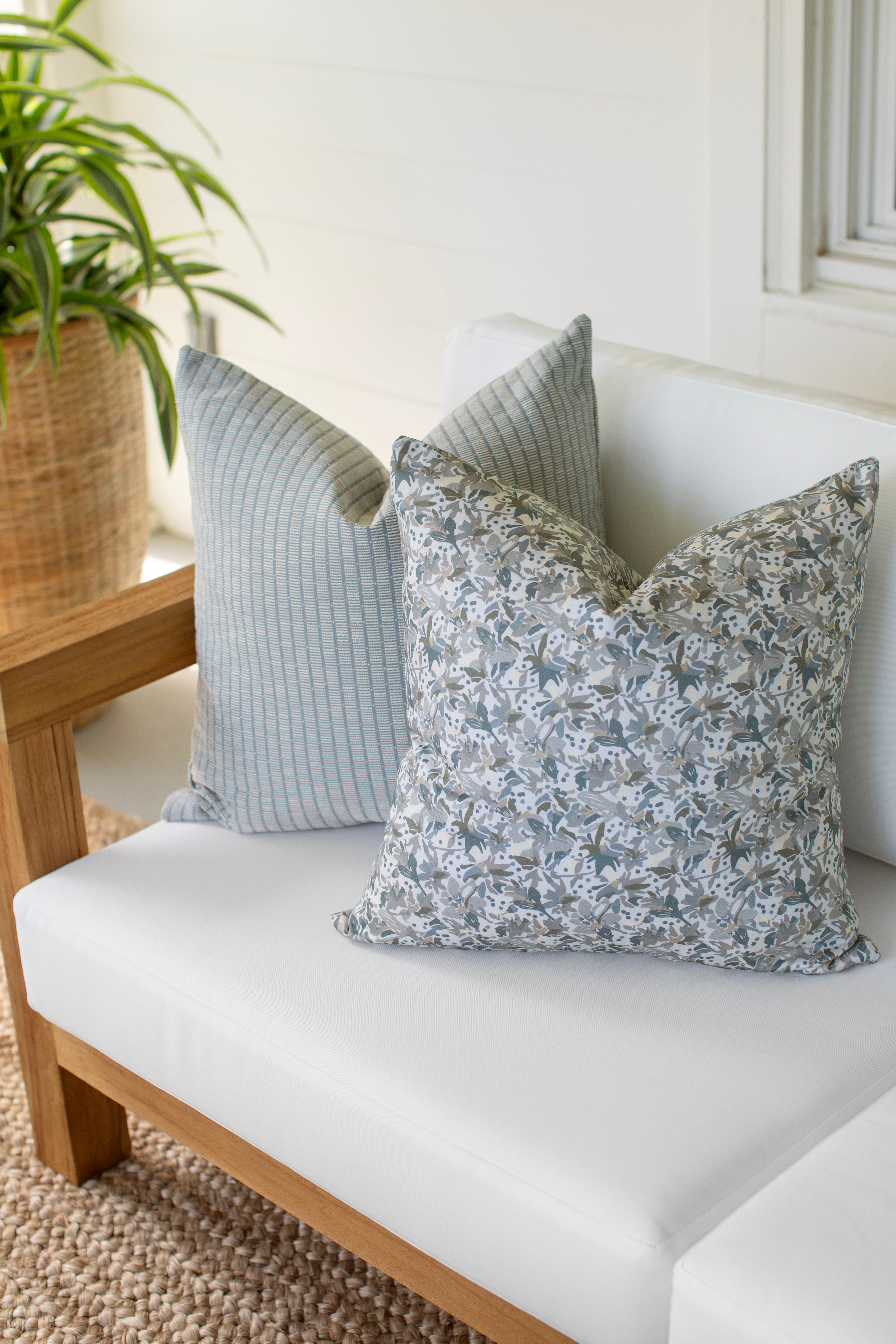 Eden pillow in Lichen styled by Emily Daws – placed on a vintage chair with warm wood tones