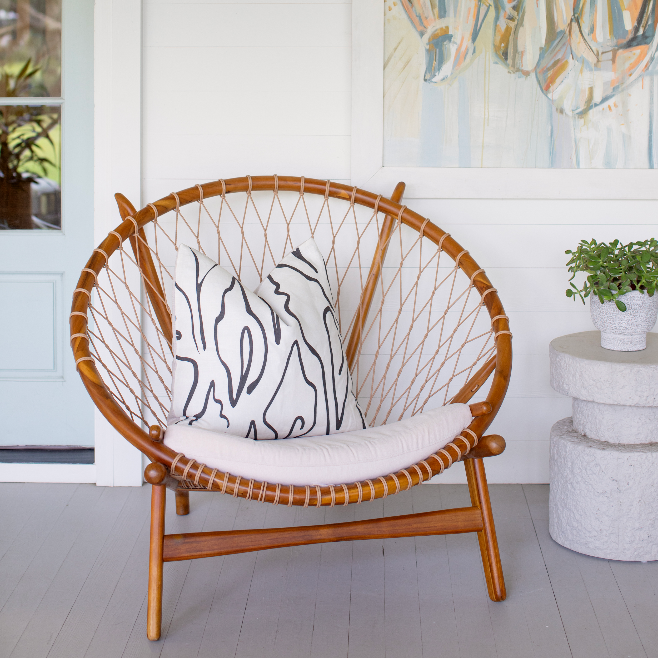 Outdoor seating styled with Emily Daws pillows in Belgian linen fabrics, created for trade professionals and clients.