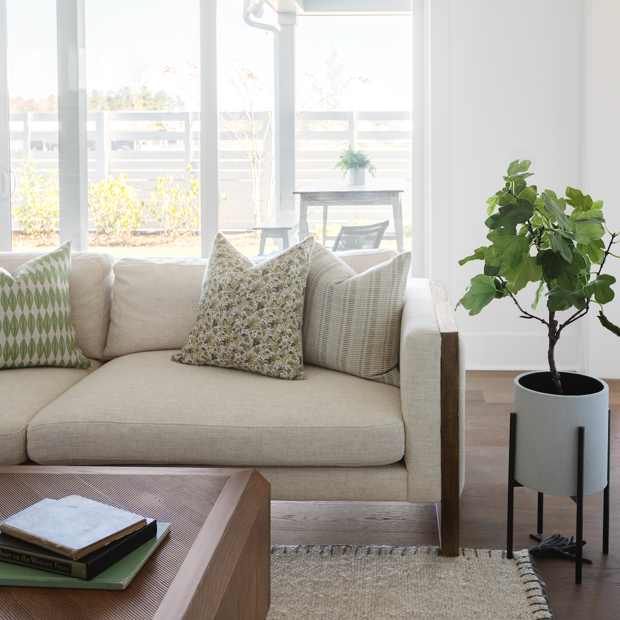 Emily Daws pillows styled in a living room with layered fabrics and patterns, designed for luxury interiors.