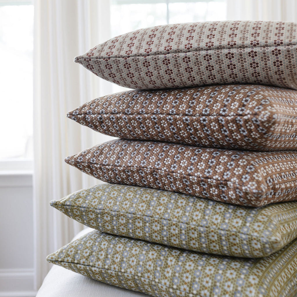 Boutique pillows in Nectarfrom Emily Daws Textiles stacked to reveal layered texture and heirloom-inspired patterns.