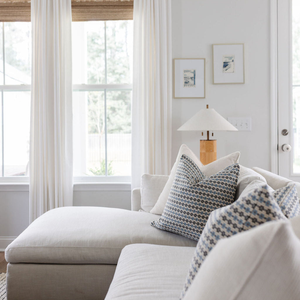 Emily Daws Nectar pillows in Cerulean Blue styled on a modern sofa, boutique textiles adding southern inspired charm to coastal interiors
