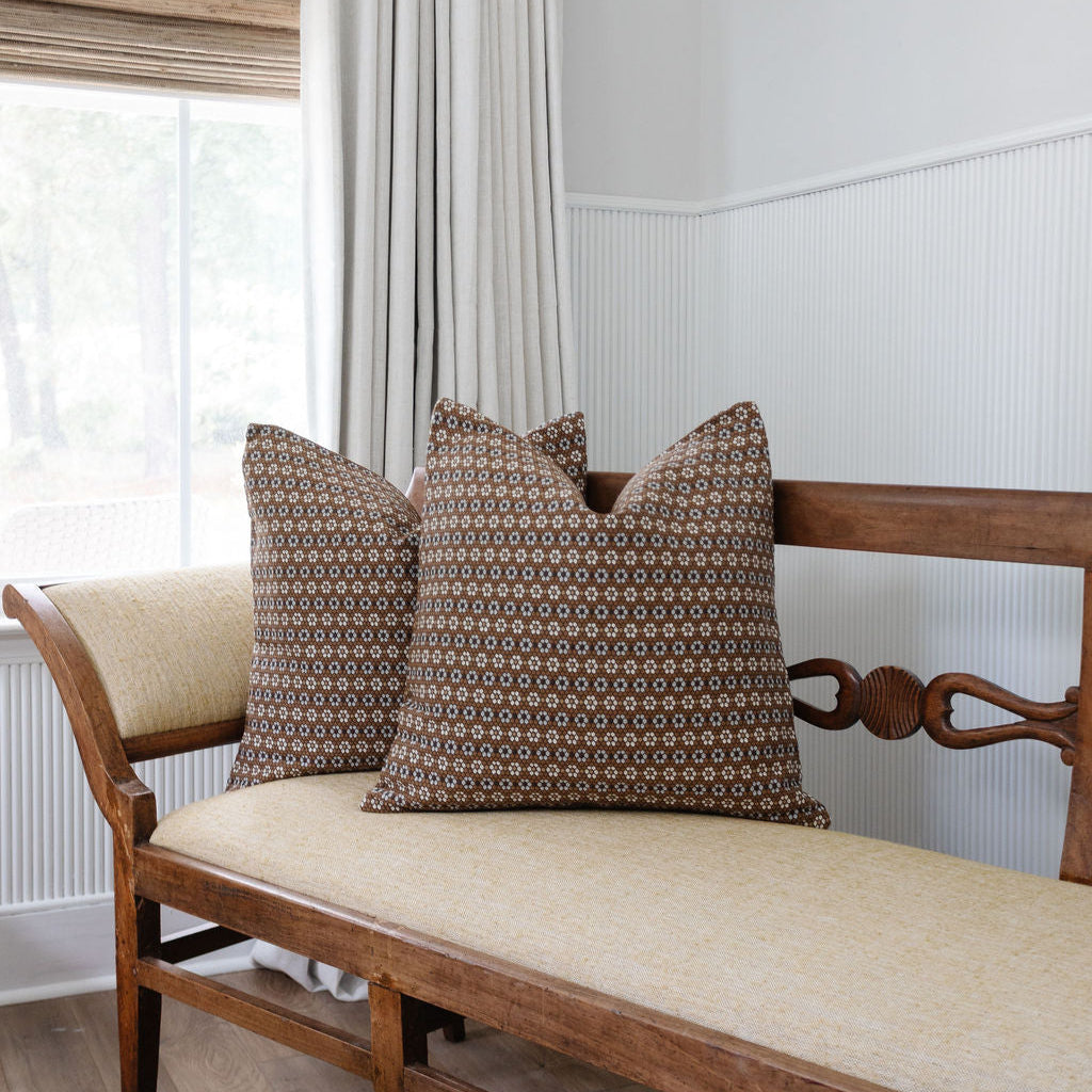 Decorative pillows by Emily Daws styled on a window seat, created for luxury interiors and relaxed moments.