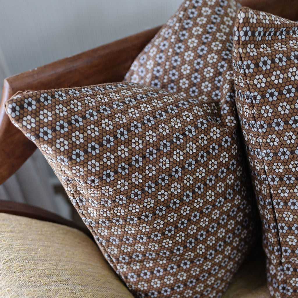 Close up view of bench seating styled with Emily Daws pillows in woven fabrics, created for trade professionals and clients.