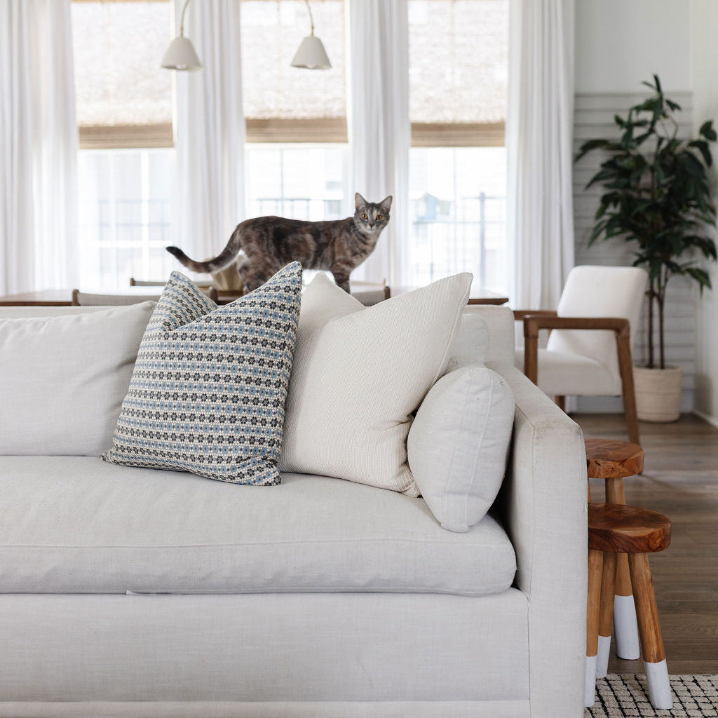 Emily Daws Nectar Cerulean Blue pillow, shown in a relaxed living room setting. Styled for classic, artful Southern interiors.
