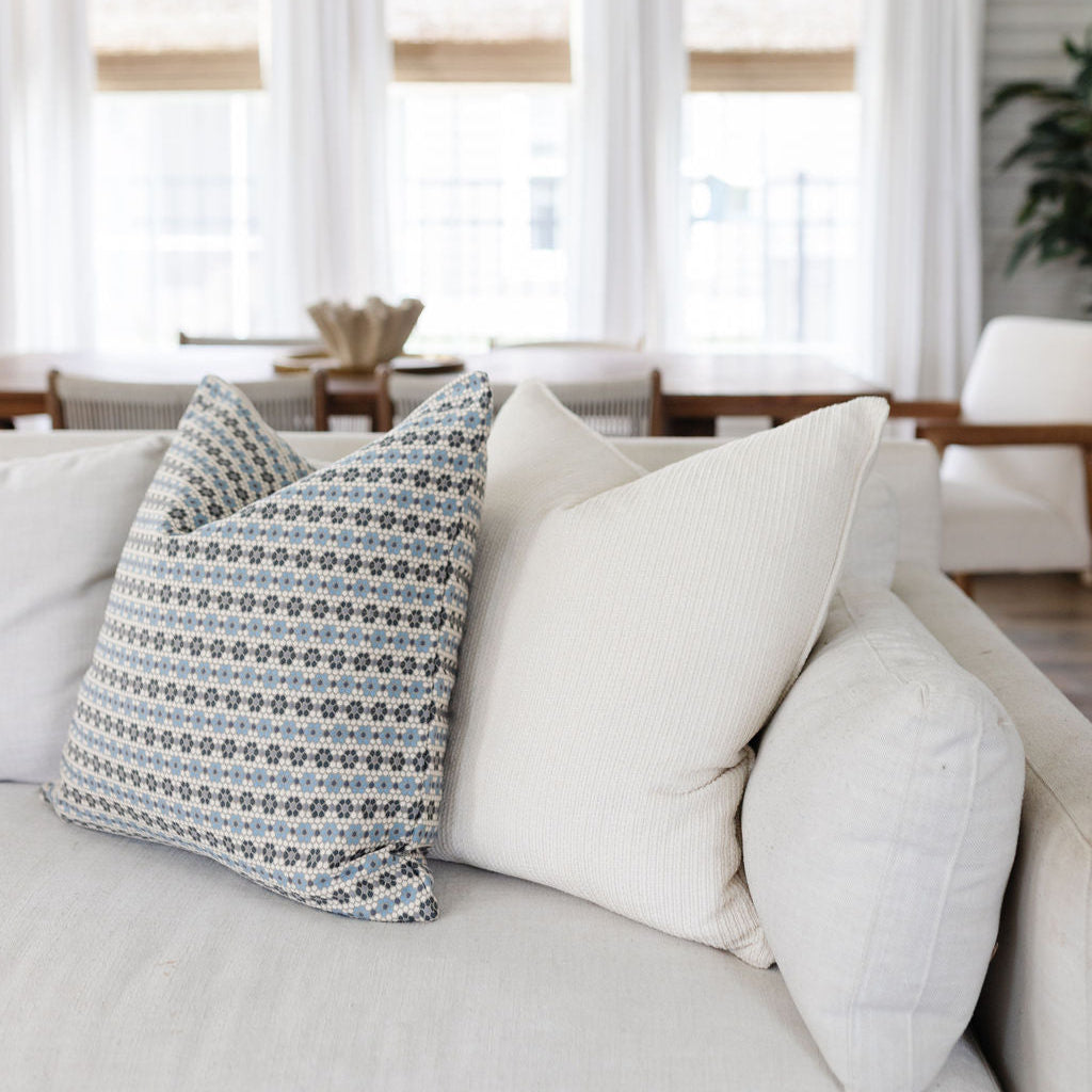 Emily Daws pillows styled in a coastal cottage living room, designed with small-batch fabrics for interior designers.