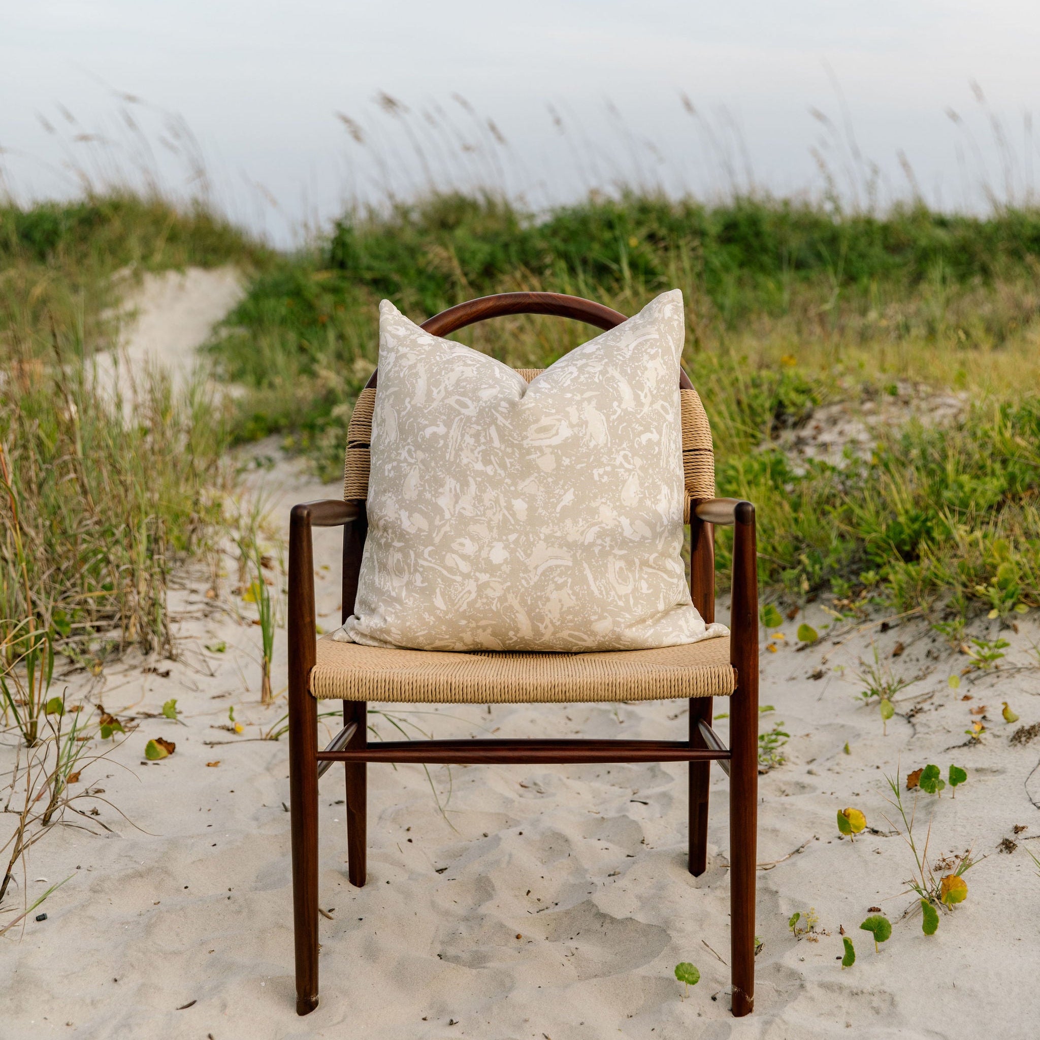 Emily Daws pillows on a chair, crafted in linen fabrics and styled for classic, artful Southern interiors.