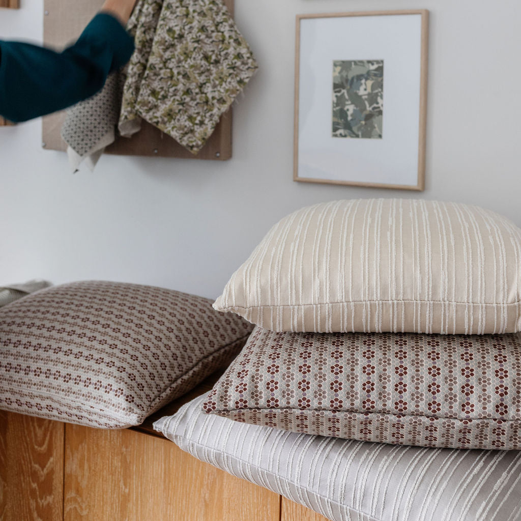 Washout in Hominy from Emily Daws Textiles, luxury woven pillows layered with companion designs. Made for timeless, storied interiors.