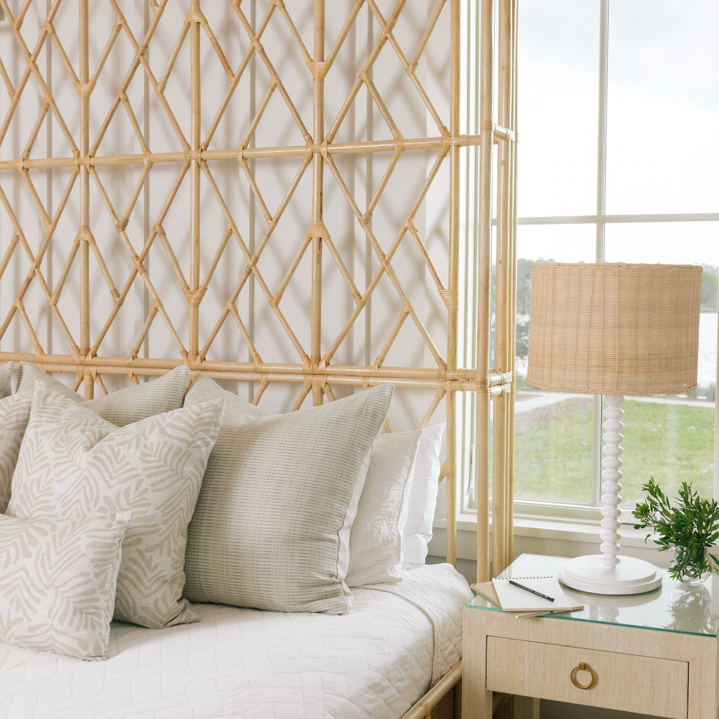 Neutral Emily Daws pillows arranged on a bed, styled to highlight small-batch fabrics and bespoke interiors.