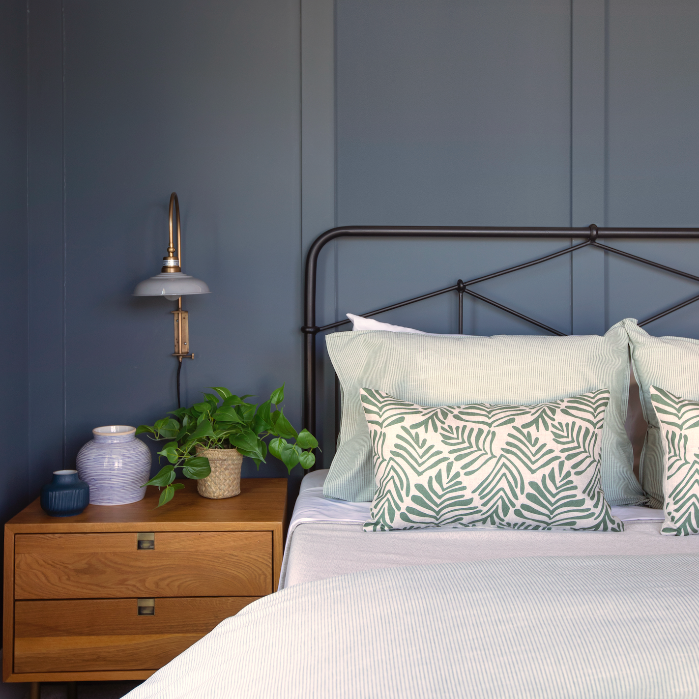 Bedroom vignette featuring Emily Daws pillows, styled with heirloom-inspired fabrics for boutique interiors.