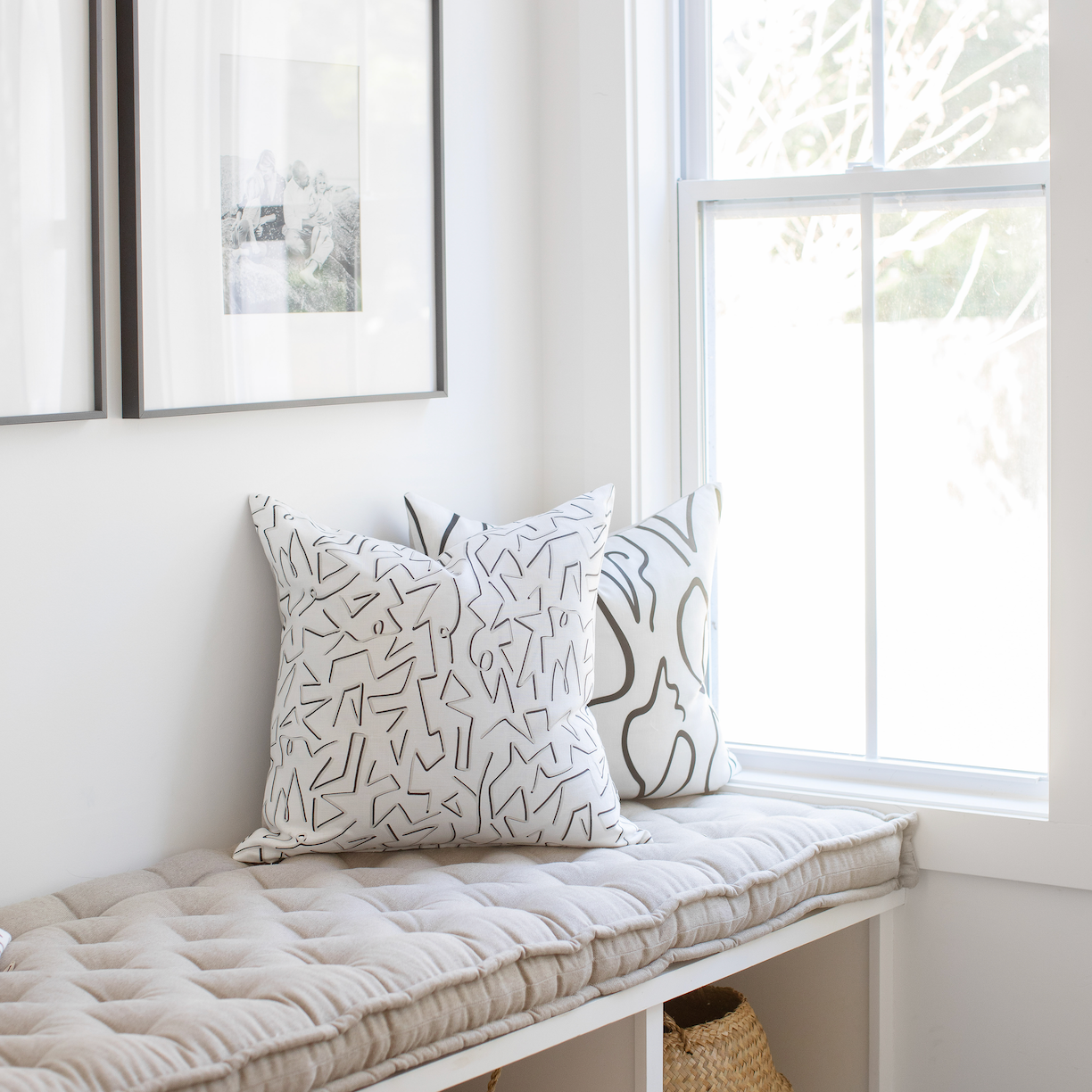 Accent pillows by Emily Daws styled on a window seat, designed for cozy spaces and bespoke interiors.