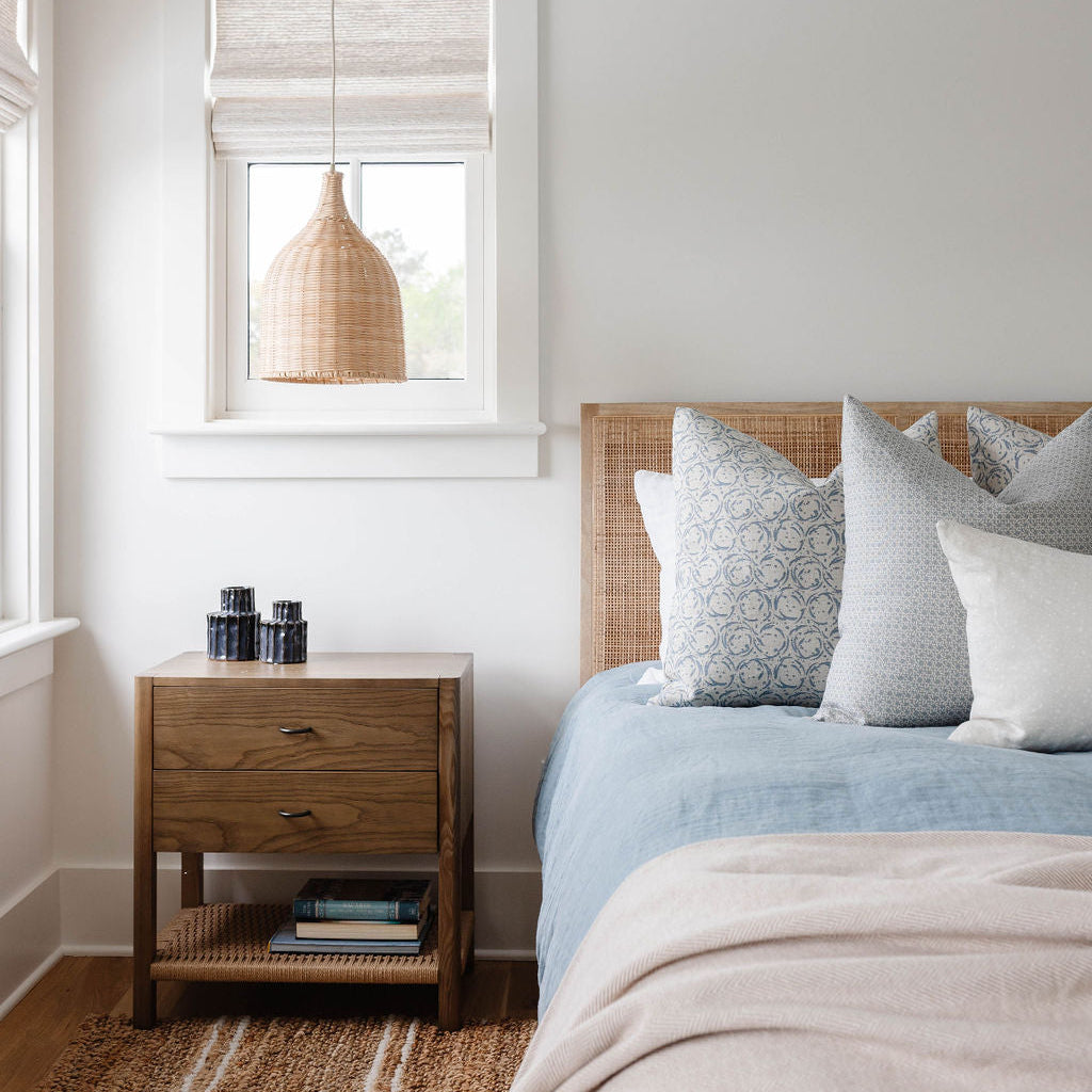 Emily Daws pillows displayed in a Charleston-inspired interior, styled with luxury textiles for artful living spaces.