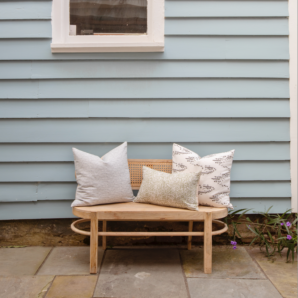 Bench seating styled with Emily Daws pillows in Belgian linen fabrics, created for trade professionals and clients.