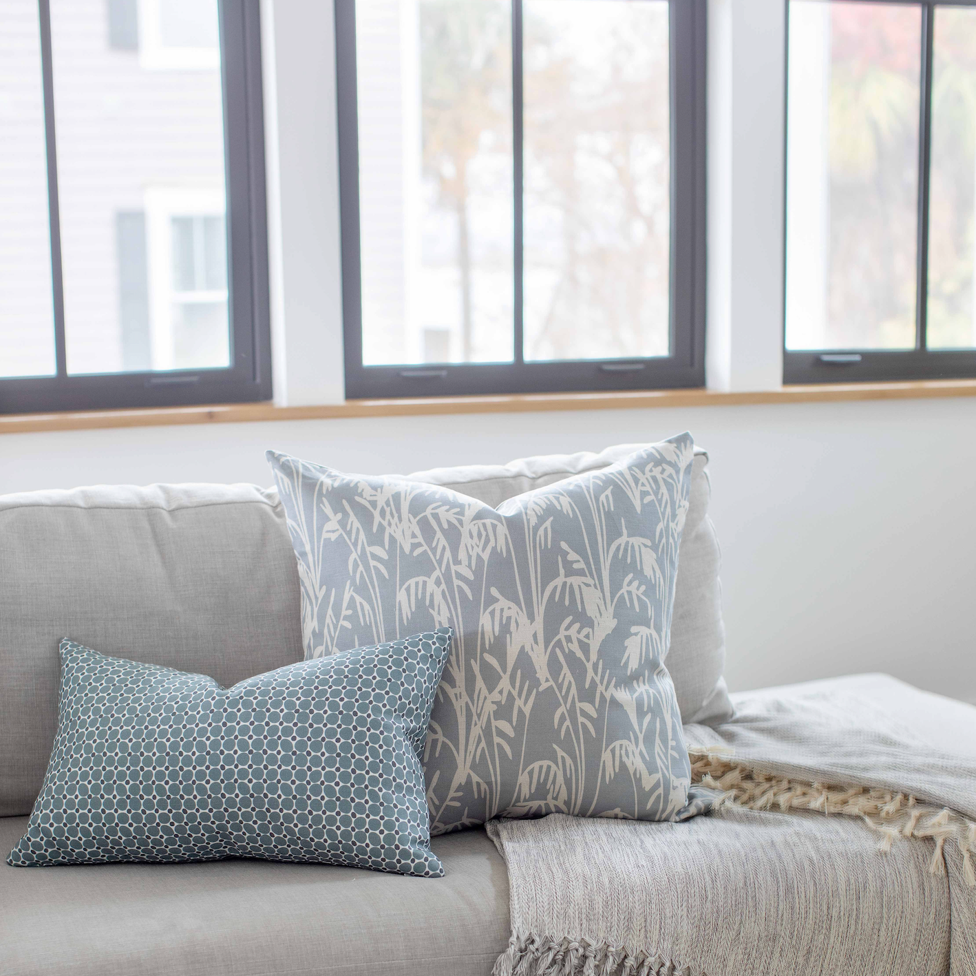 Styled sofa with Emily Daws pillows in small-batch fabrics, designed for interior designers and bespoke interiors.