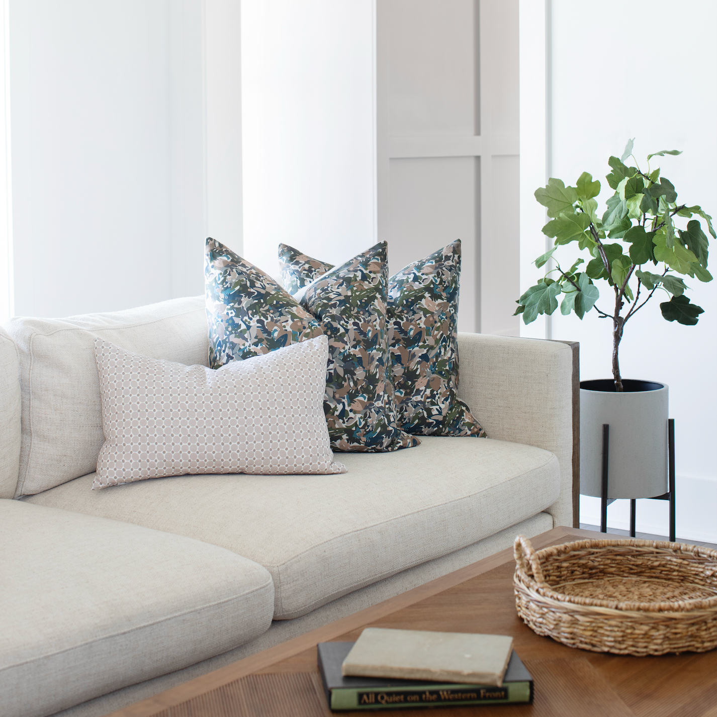 Collection of Emily Daws pillows styled on a sofa, showcasing bespoke fabrics, wallcoverings, and Southern design.