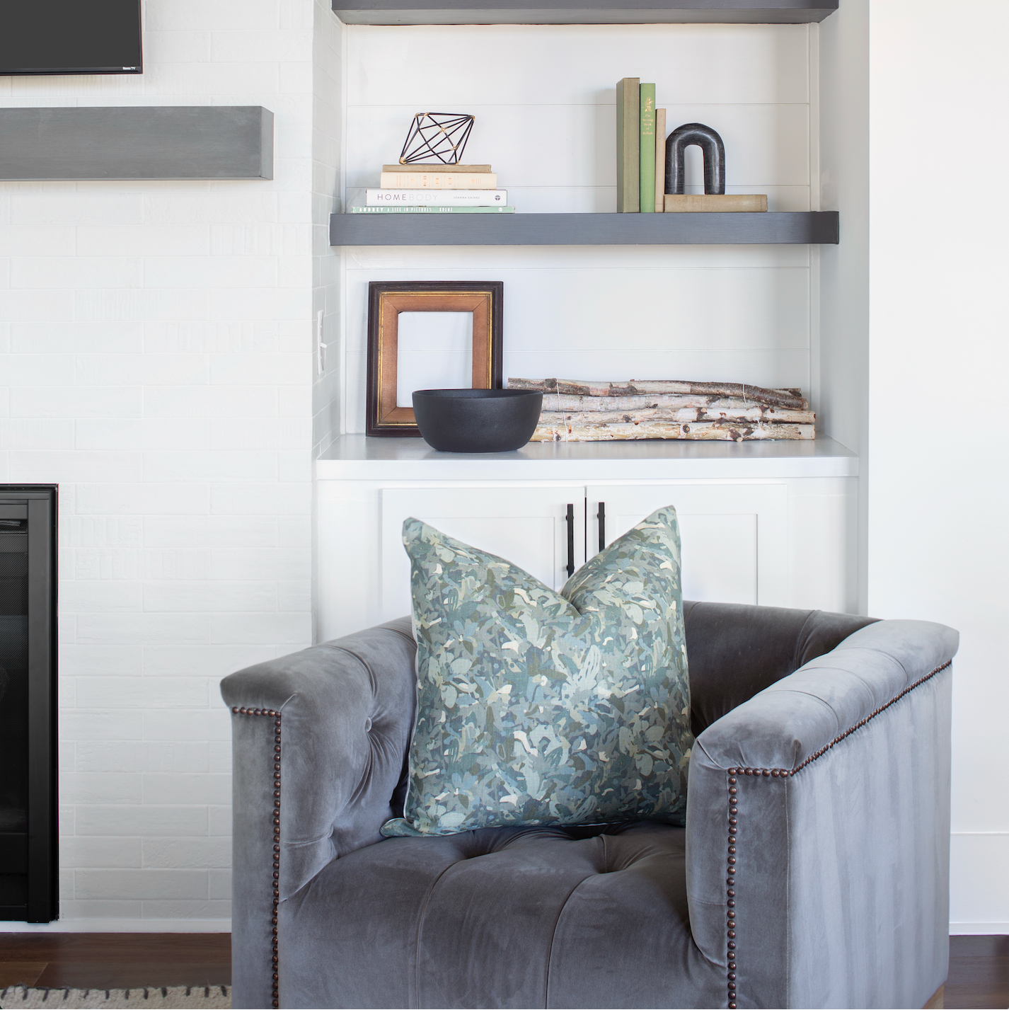 Armchair styled with Emily Daws pillows, featuring handcrafted details and linen fabrics for classic interiors.