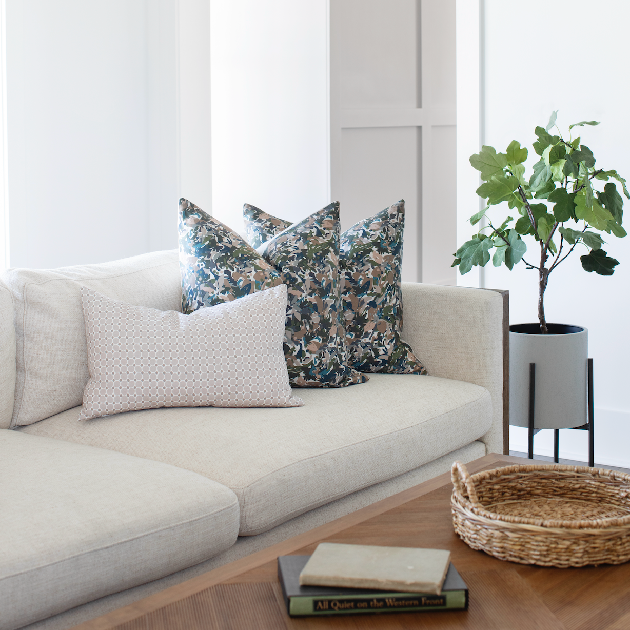 Collection of Emily Daws pillows styled on a sofa, showcasing bespoke fabrics, wallcoverings, and Southern design.