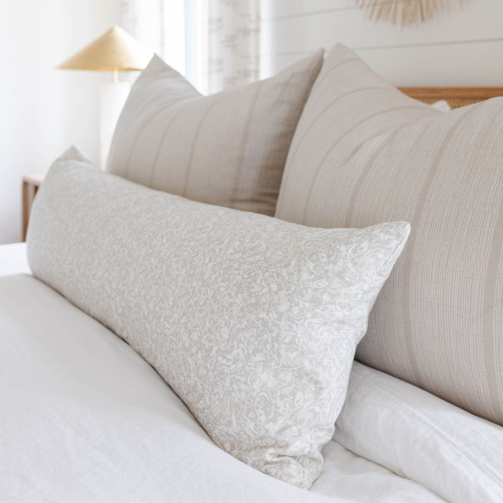 Estuary pillow in Drift styled by Emily Daws – placed on a cane chair in a Charleston sunroom