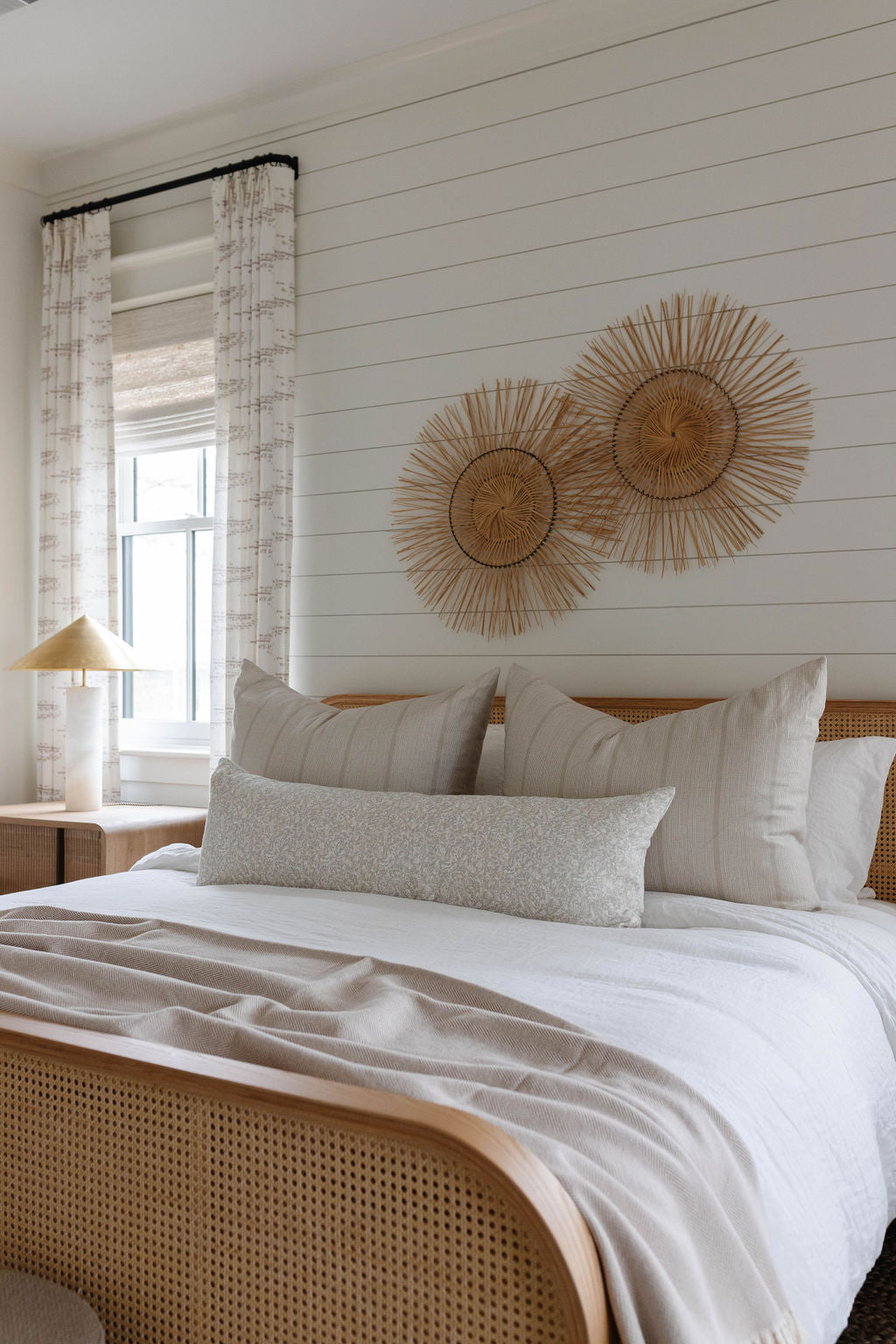 Estuary pillow in Drift styled by Emily Daws – shown on a porch bench with other woven accents