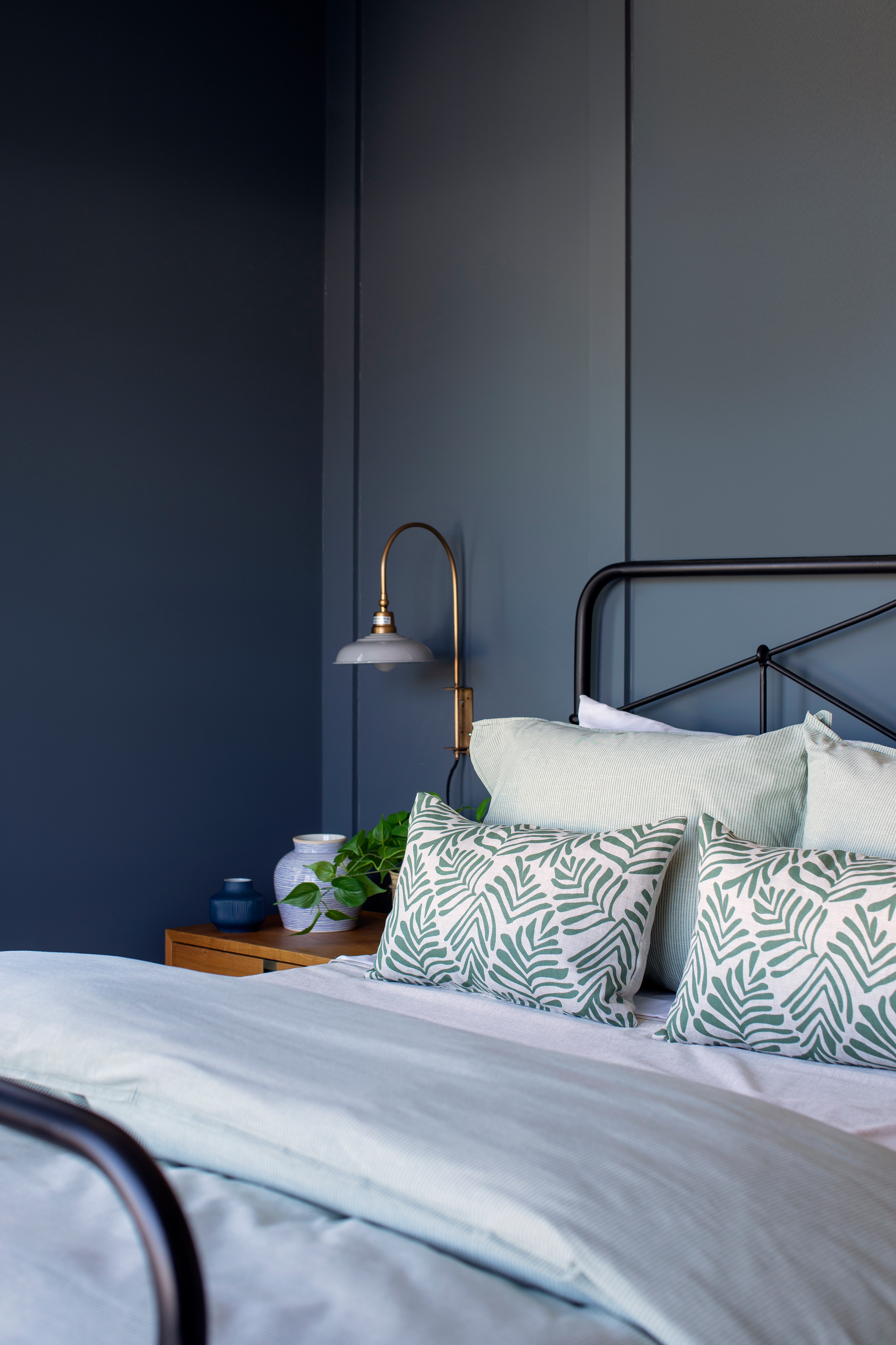 Frond pillow in Alpine styled by Emily Daws – placed on a vintage chair with warm wood tones