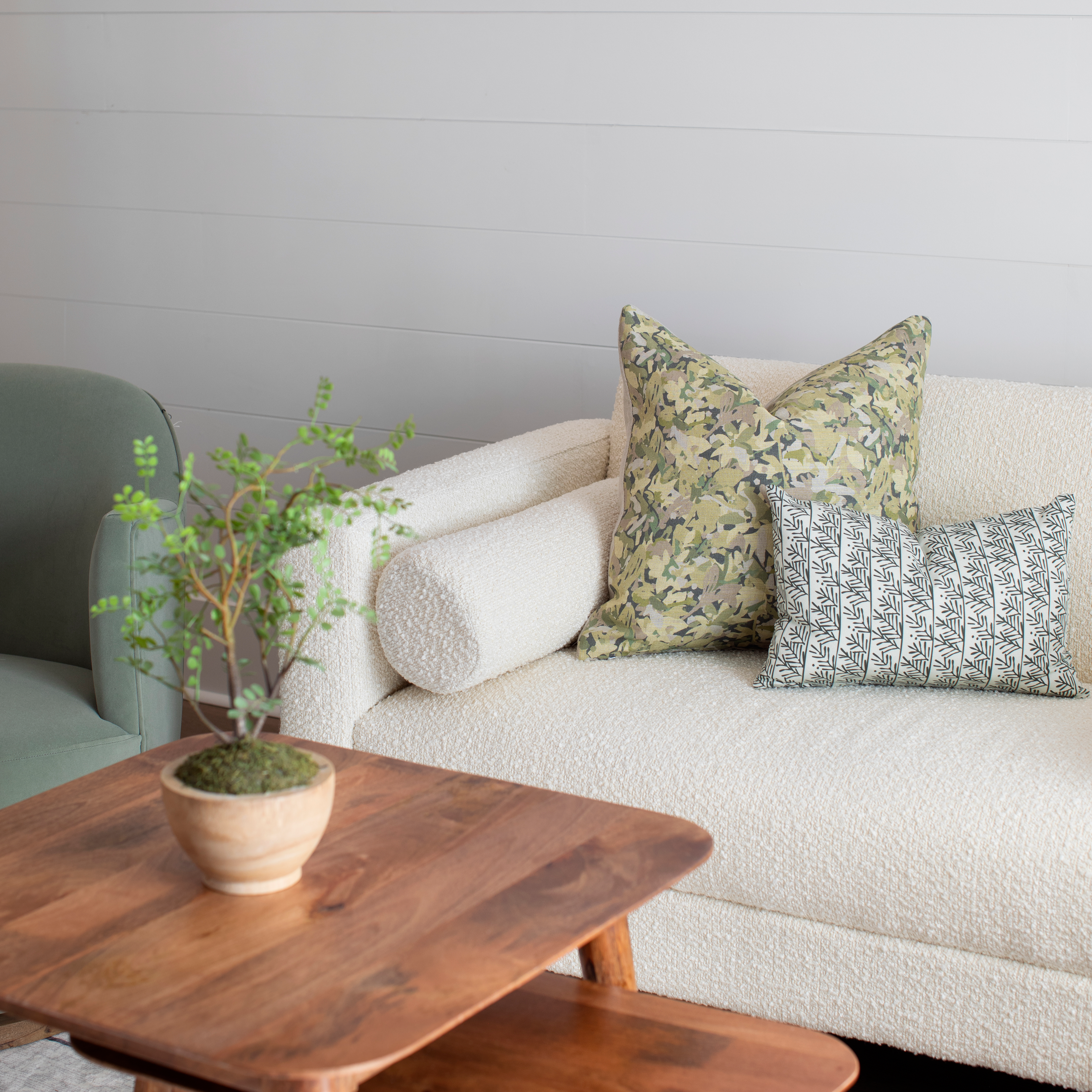 Hemlock pillow in Holly styled by Emily Daws β layered with quilts in a woodland bedroom setting