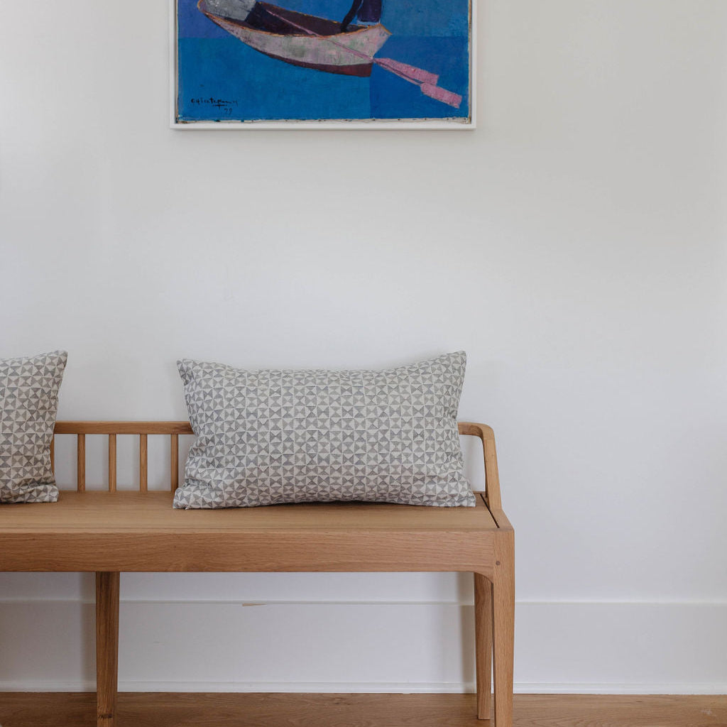 Kaleidoscope pillow in Cashmere styled by Emily Daws – shown on a rustic bench with handmade quilts