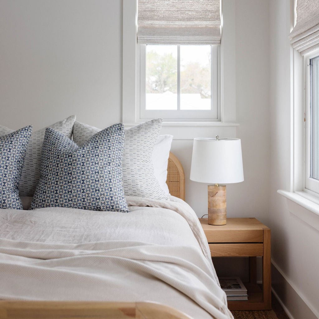 Kaleidoscope pillow in Iris styled by Emily Daws β shown on a rustic bench with handmade quilts