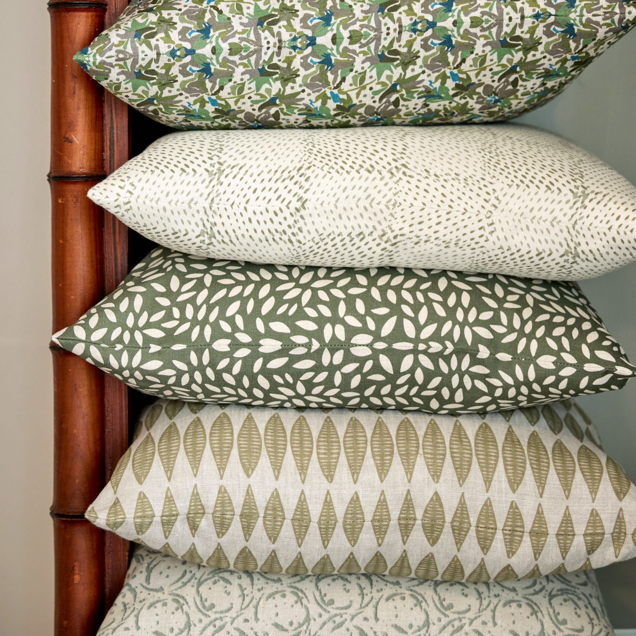 Leaflette pillow in Lemongrass styled by Emily Daws – placed on a vintage chair with warm wood tones