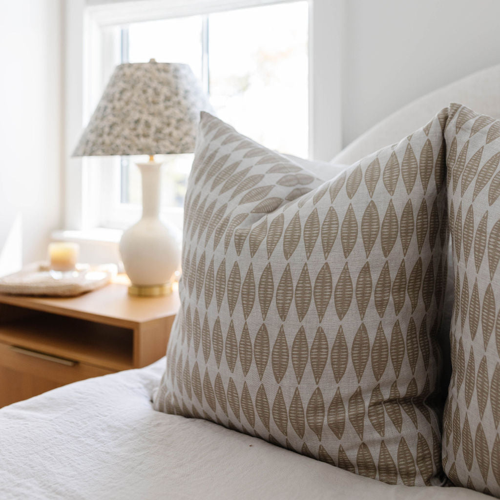 Leaflette pillow in Suede styled by Emily Daws β layered with quilts in a woodland bedroom setting