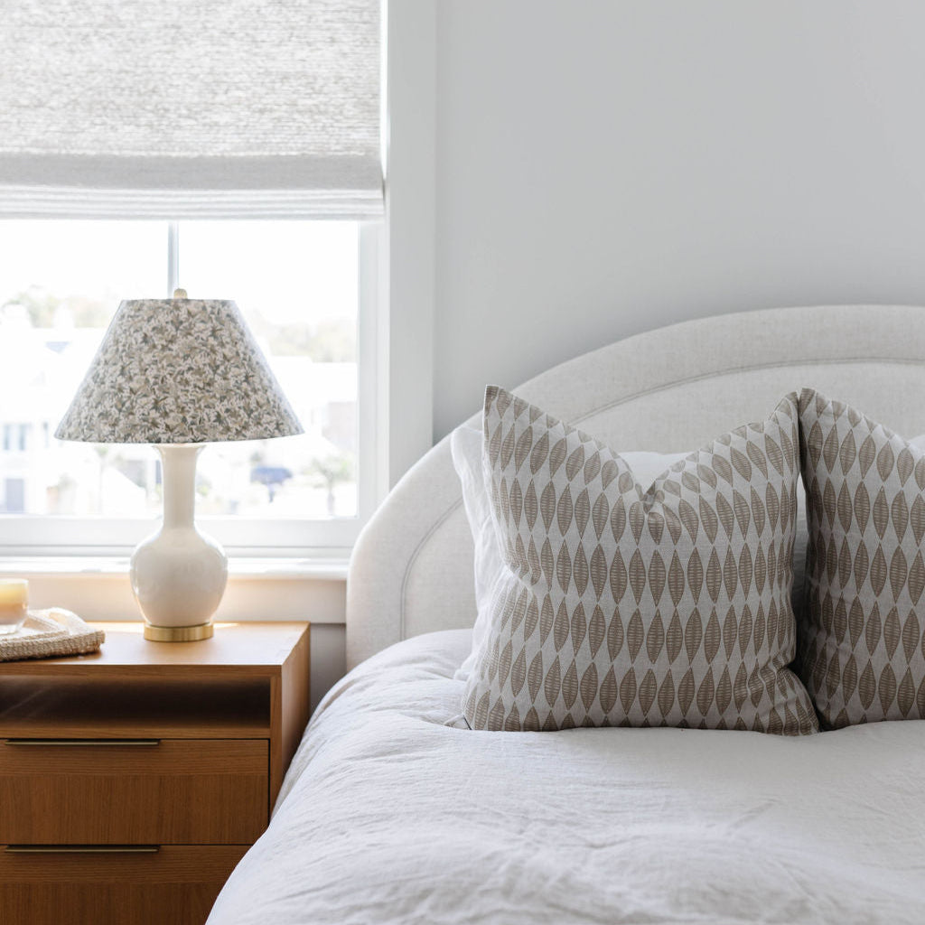 Leaflette pillow in Suede styled by Emily Daws – placed on a vintage chair with warm wood tones
