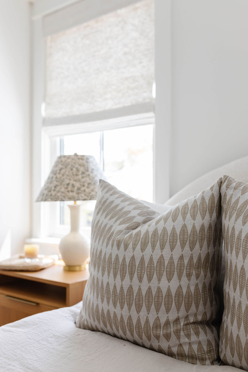 Leaflette pillow in Suede styled by Emily Daws – layered with quilts in a woodland bedroom setting