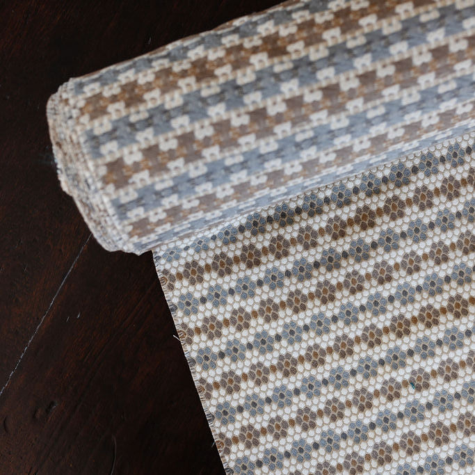 Nectar fabric in Raisin – close-up of texture and animal or insect pattern; ideal for pillows