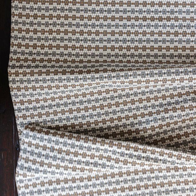 Nectar fabric in Raisin – close-up of texture and animal or insect pattern; ideal for pillows