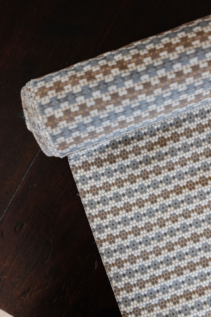 Nectar fabric in Raisin – close-up of texture and animal or insect pattern; ideal for pillows