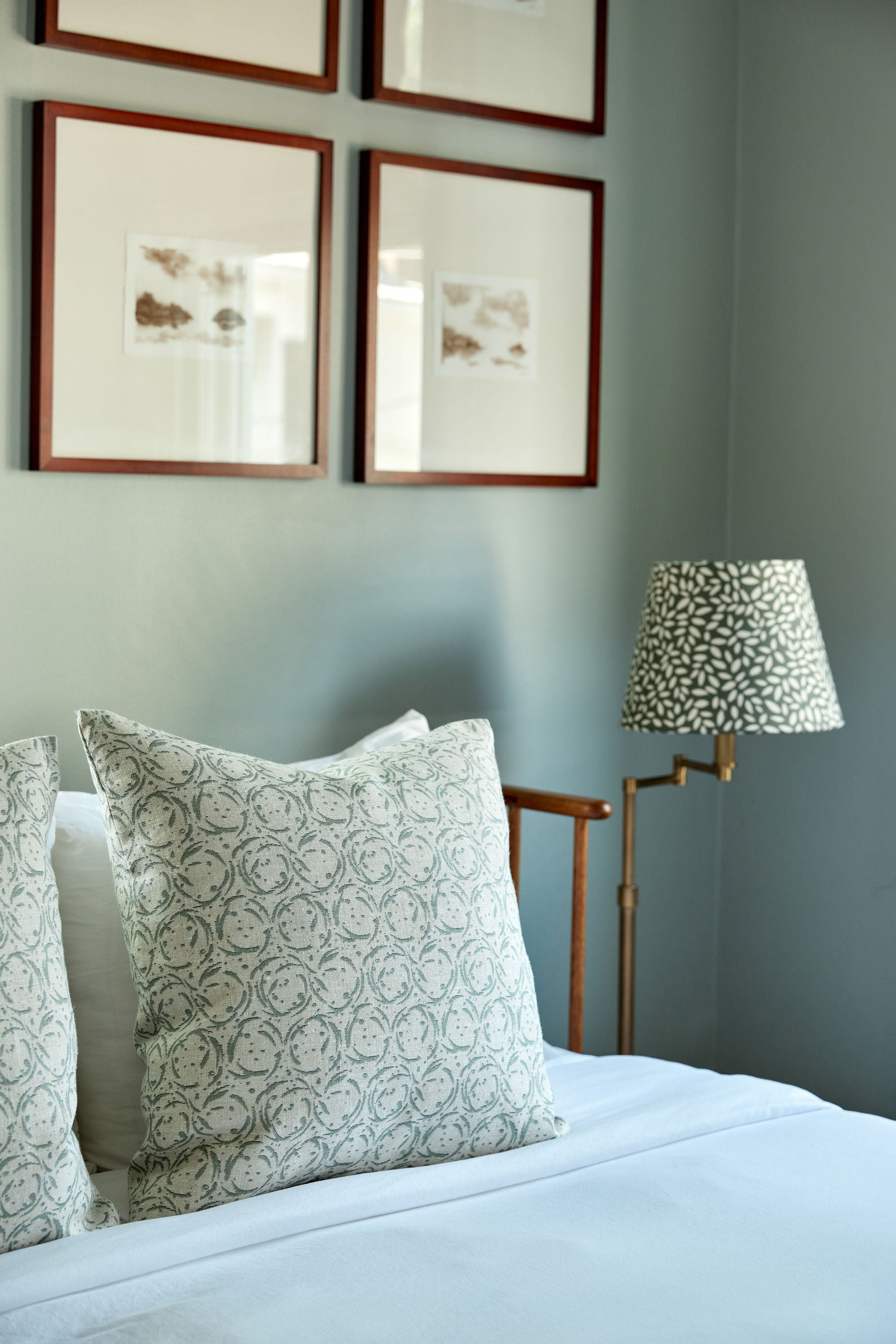 Nest pillow in Eucalyptus styled by Emily Daws – shown on a rustic bench with handmade quilts