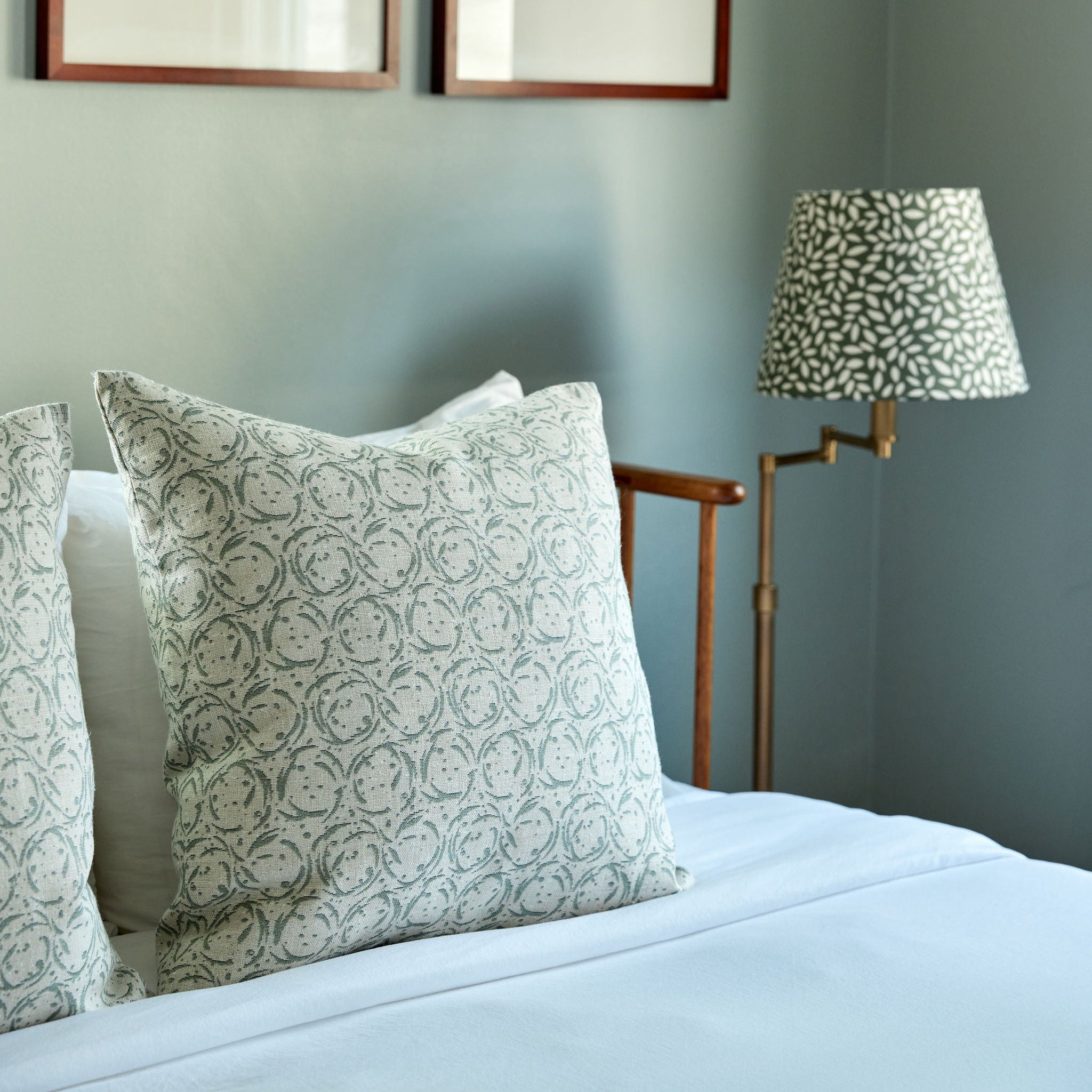 Nest pillow in Eucalyptus styled by Emily Daws β shown on a rustic bench with handmade quilts