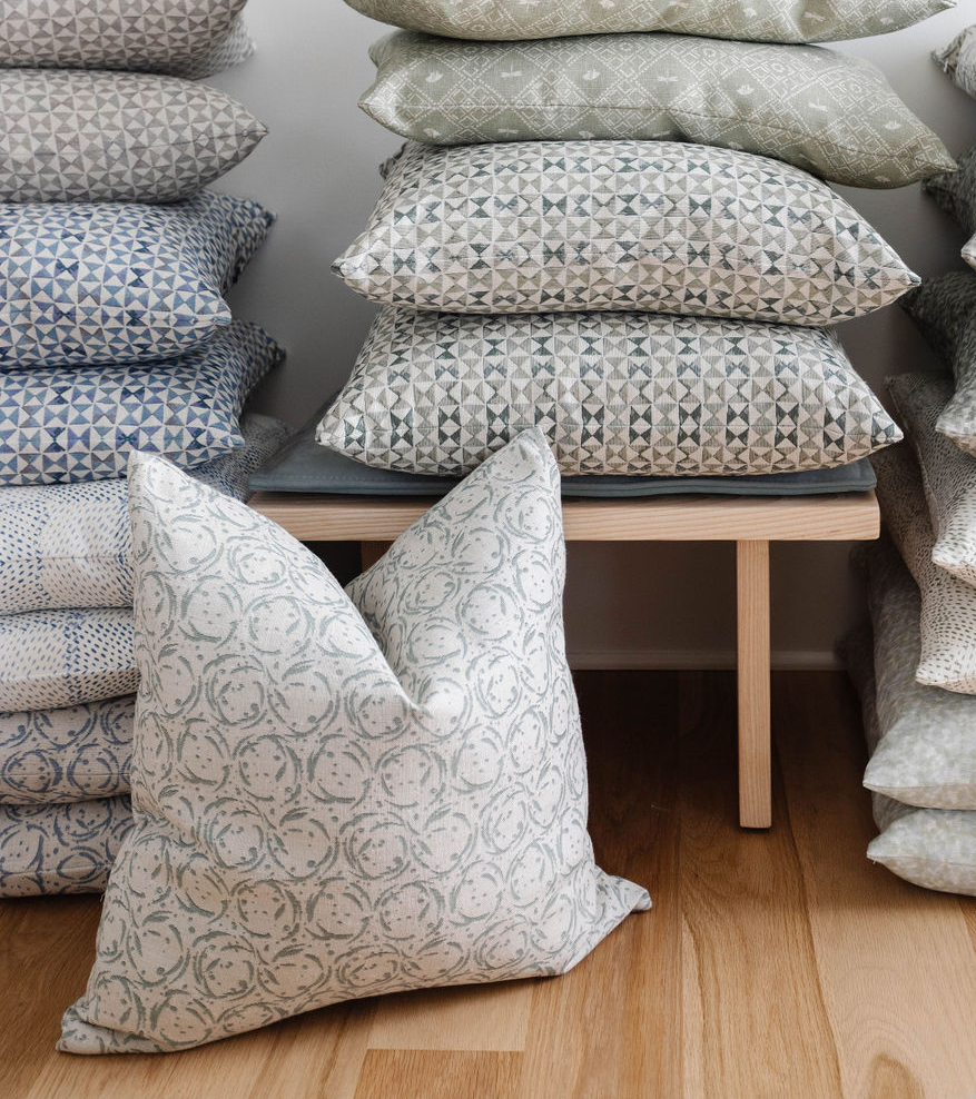 Nest pillow in Raindrop styled by Emily Daws – shown on a rustic bench with handmade quilts