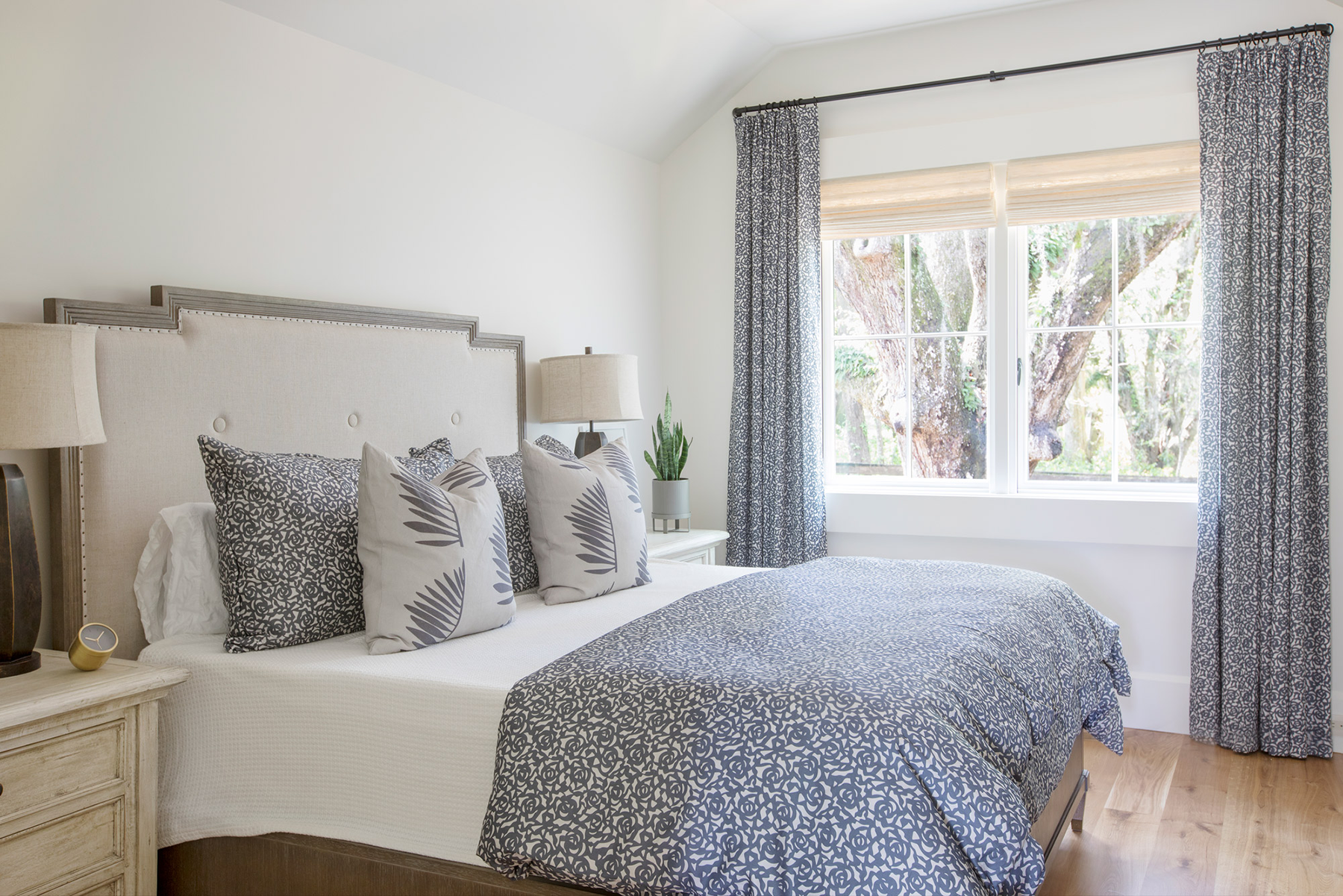 Palmetto pillow in Midnight styled by Emily Daws – placed on a vintage settee in a Charleston cottage