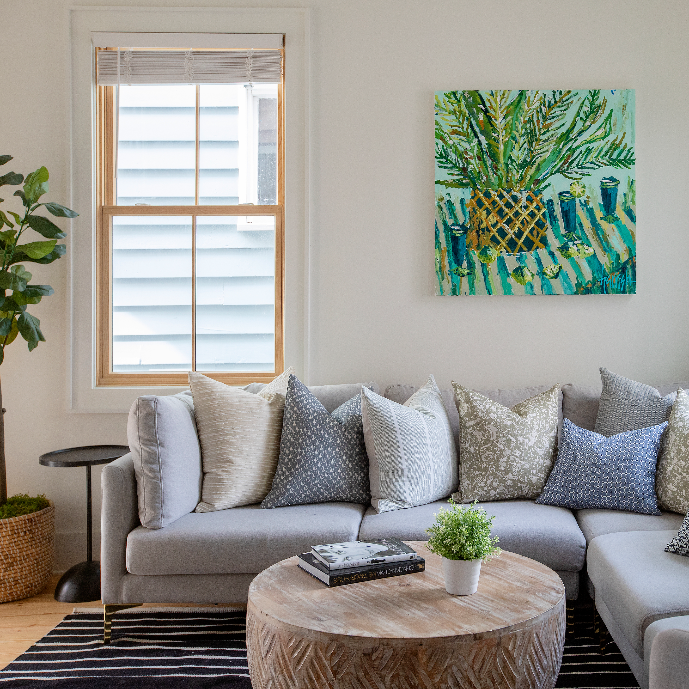 Sofa styled with Emily Daws River Reef pillows in Belgian linen, made in the South for luxury interiors.