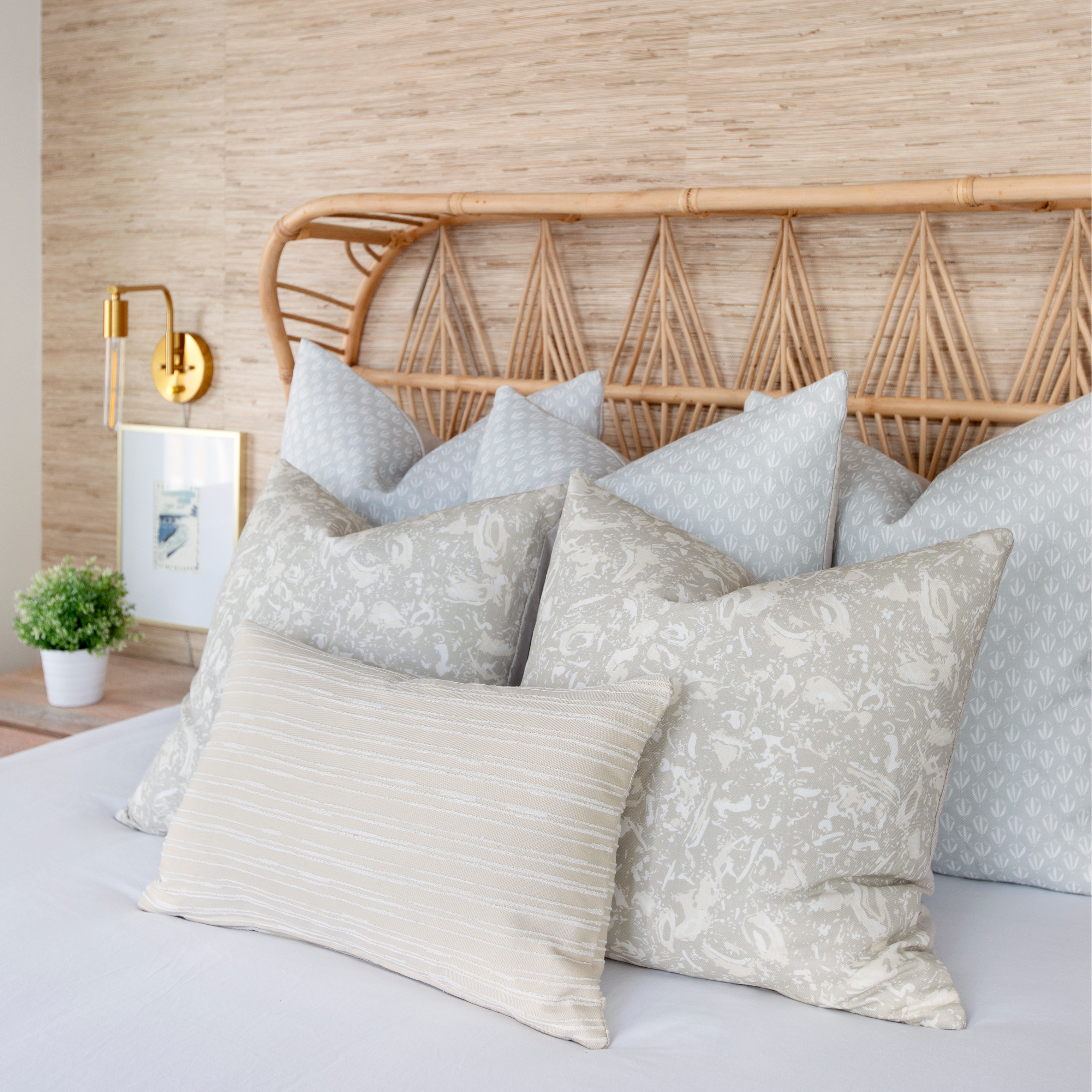 River Reef pillow in Marble styled by Emily Daws – placed on a cane chair in a Charleston sunroom