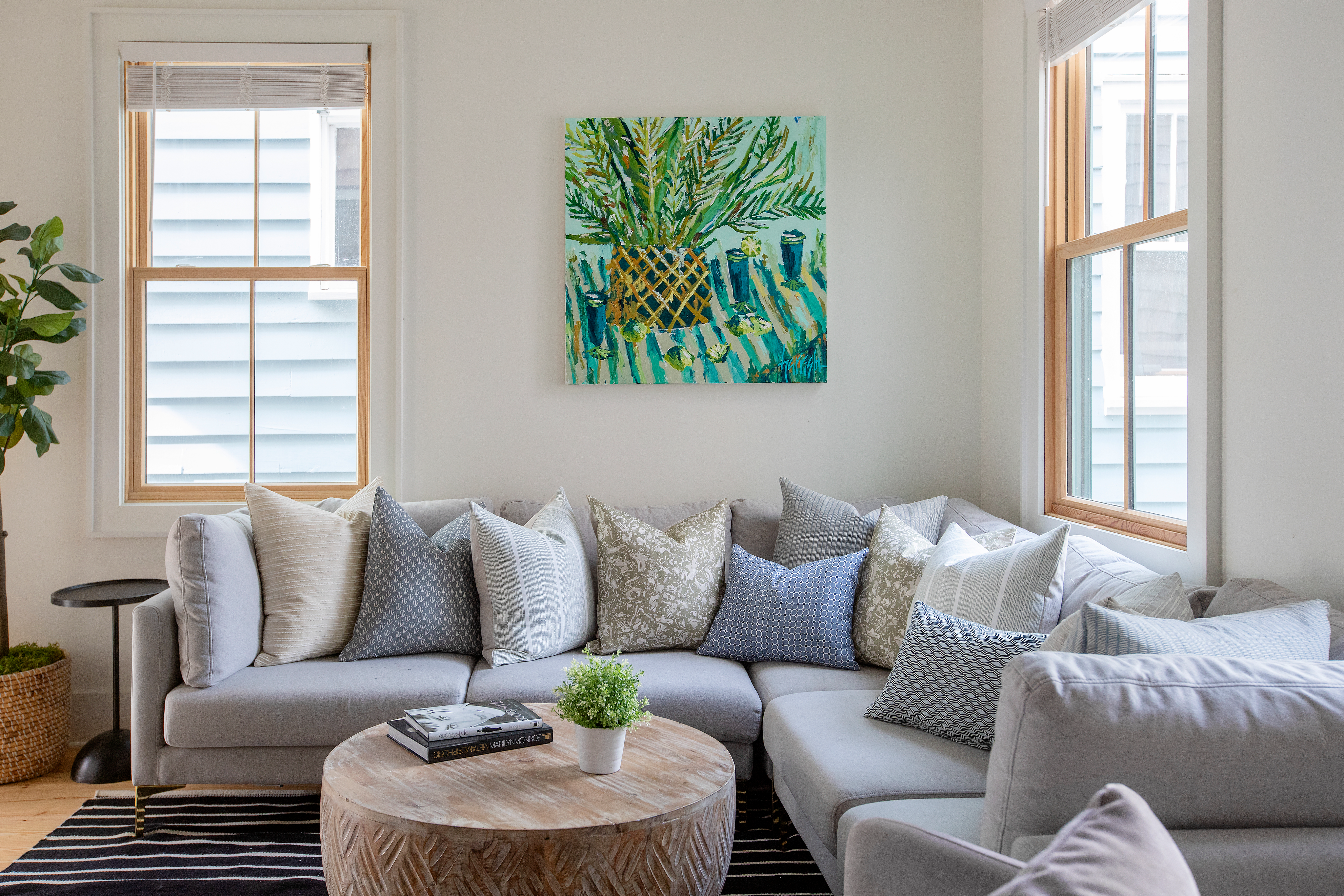 River Reef pillow in Hazel styled by Emily Daws – placed on a cane chair in a Charleston sunroom