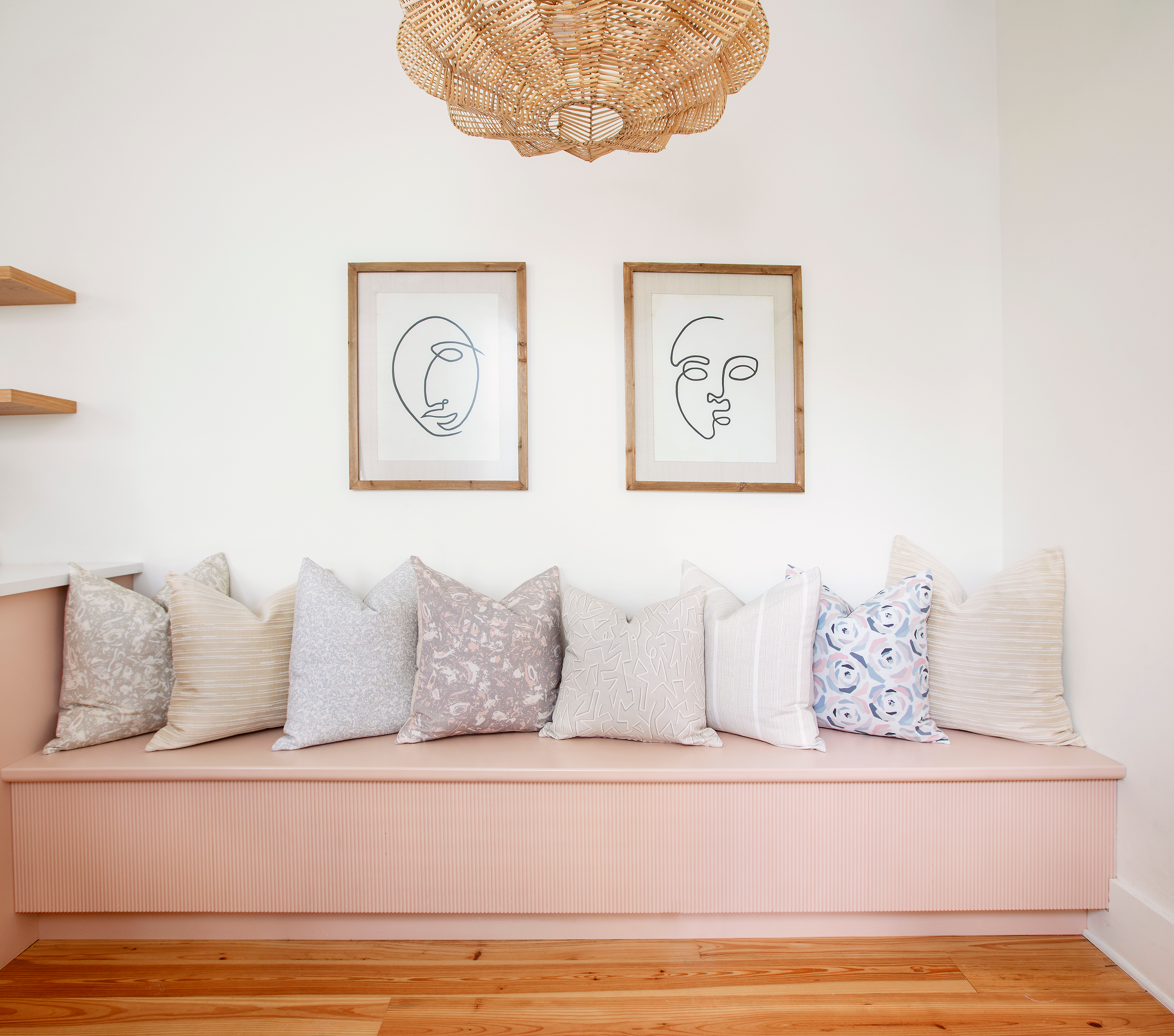 River Reef pillow in Sunset styled by Emily Daws – placed on a cane chair in a Charleston sunroom