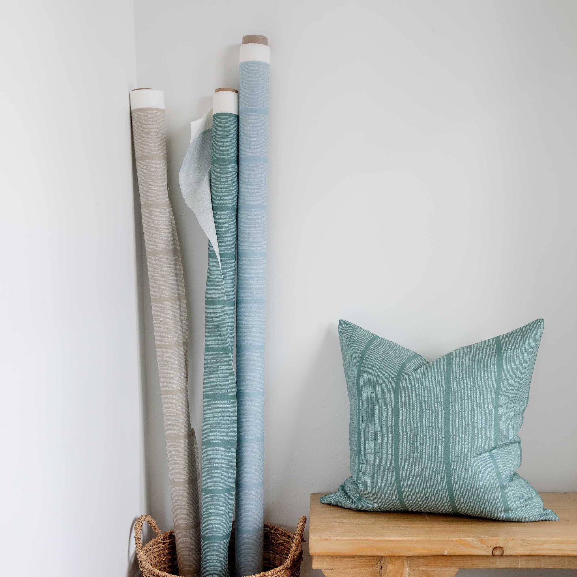 Sandbar pillow in Pool styled by Emily Daws – placed on a cane chair in a Charleston sunroom