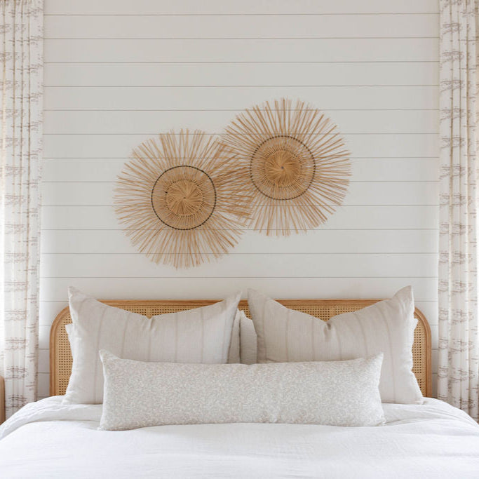 Sandbar pillow in Teak styled by Emily Daws – shown on a porch bench with other woven accents