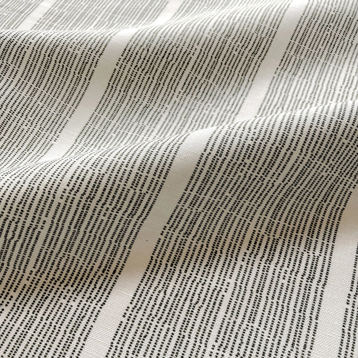 Sandbar Jet pillow by Emily Daws styled in an interior — Waterways Collection